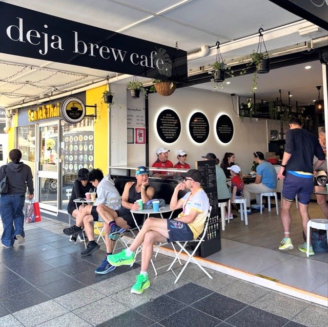 Outside picture of busy cafe Deja Brew in Southport with customers sitting inside and outside enjoying coffee and conversation.