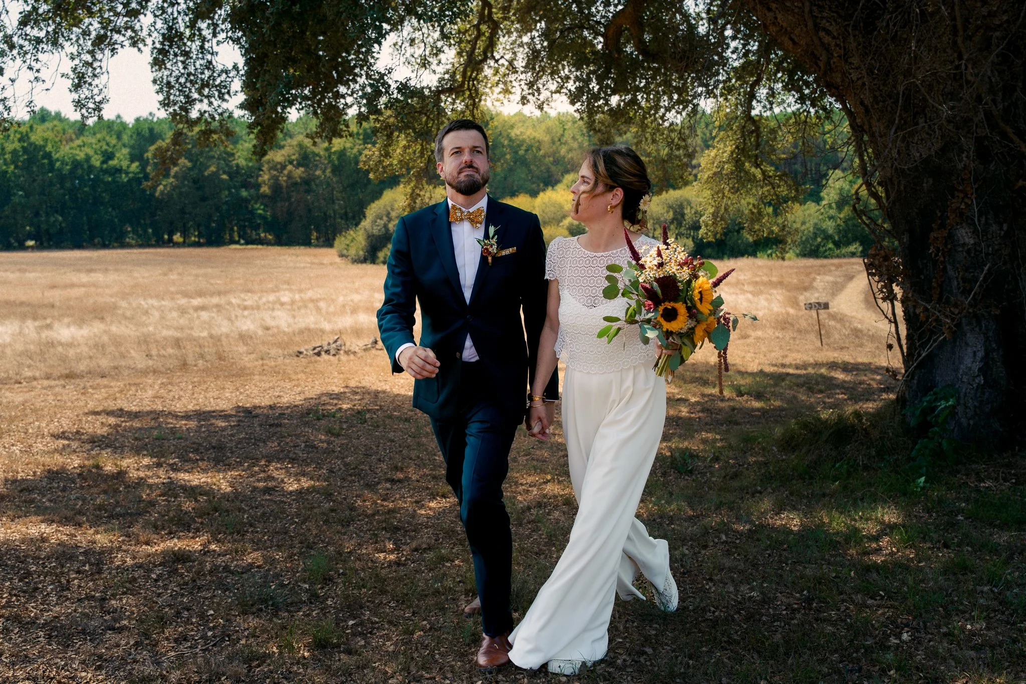 photographe-mariage-pays-basque-maries-marchent-prairie-sous-les-chenes.jpg
