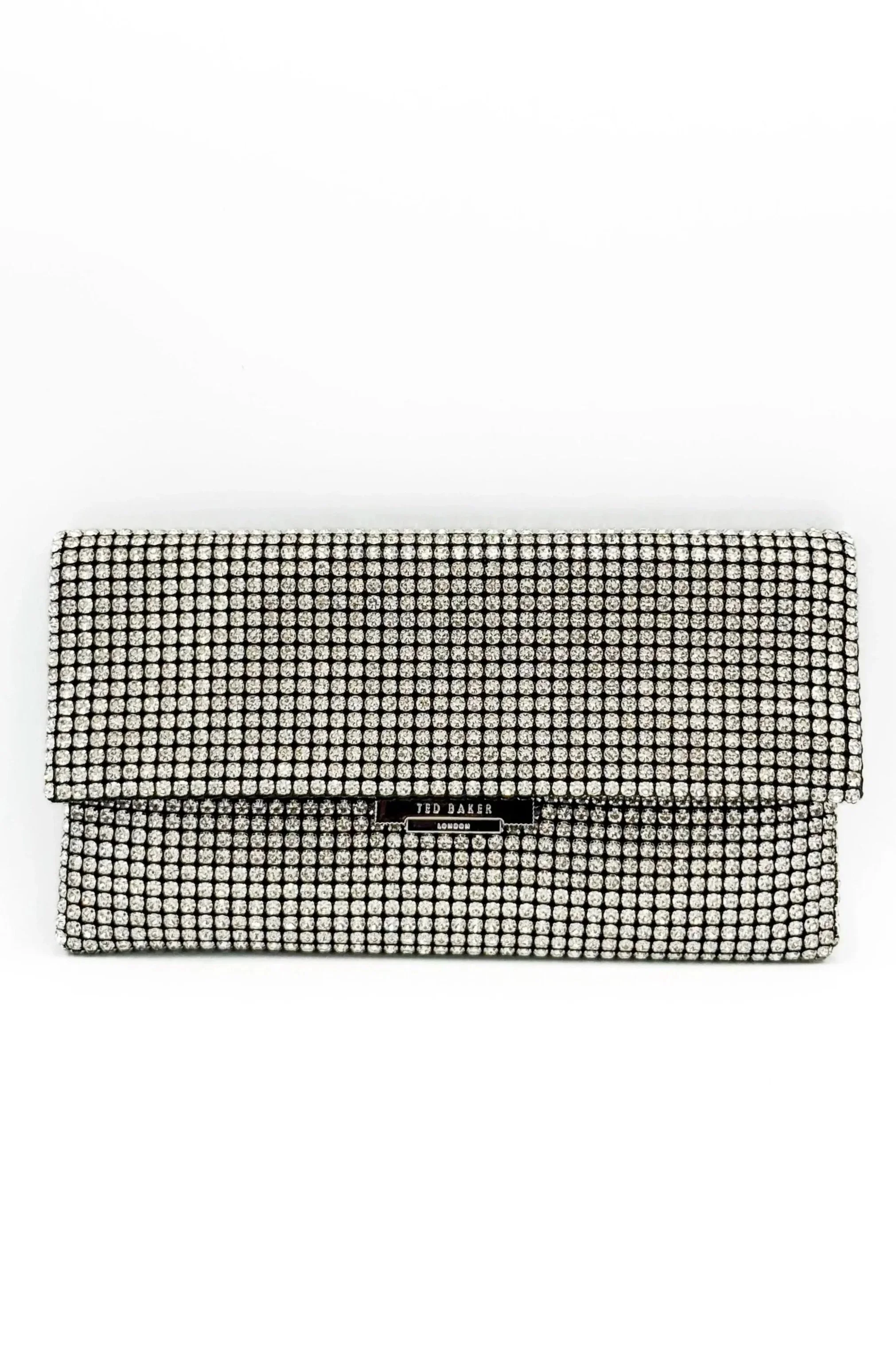 A Ted Baker clutch purse covered in rhinestones with a black label on the front.