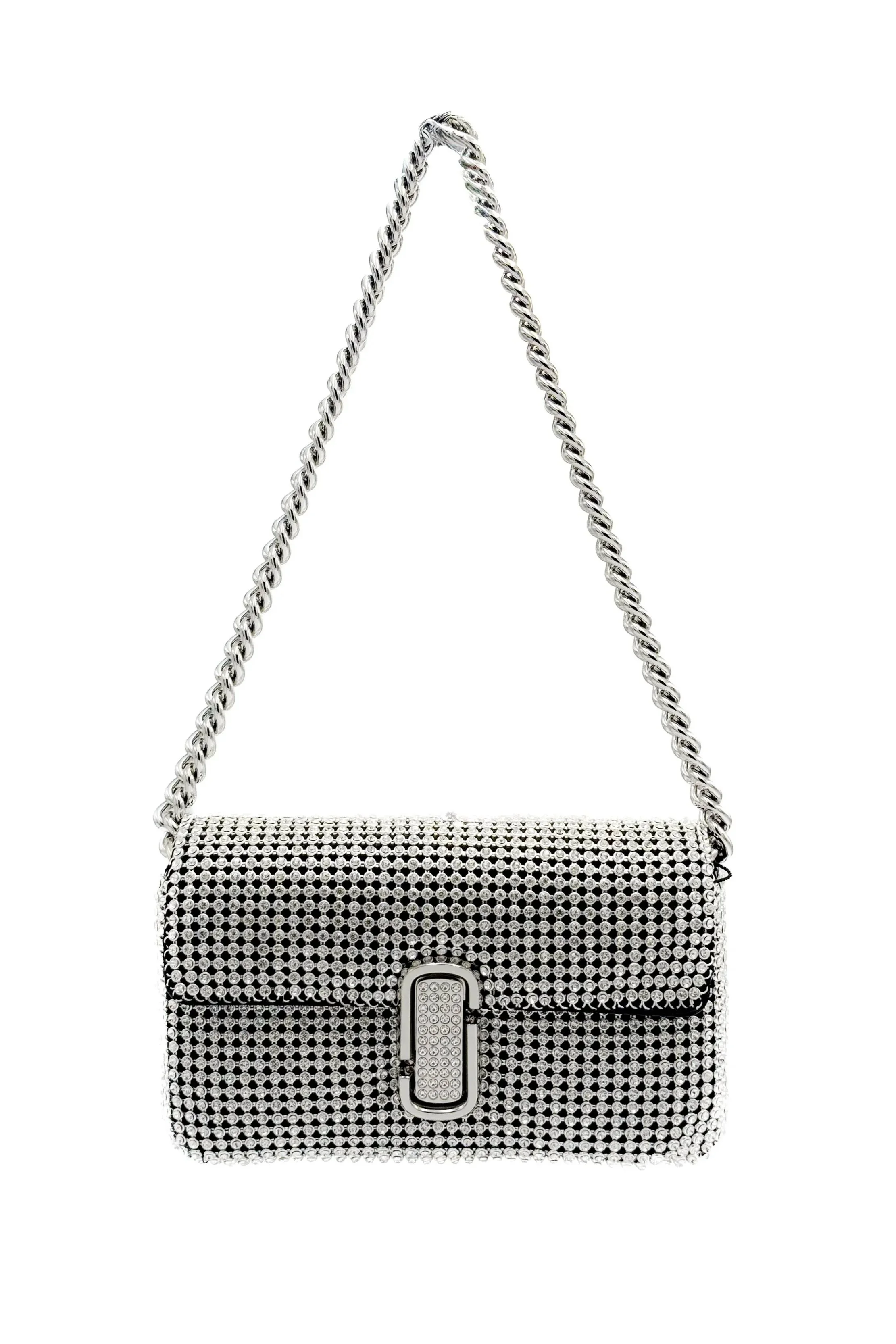 A silver handbag encrusted with rhinestones, with a chain strap and a decorative clasp.