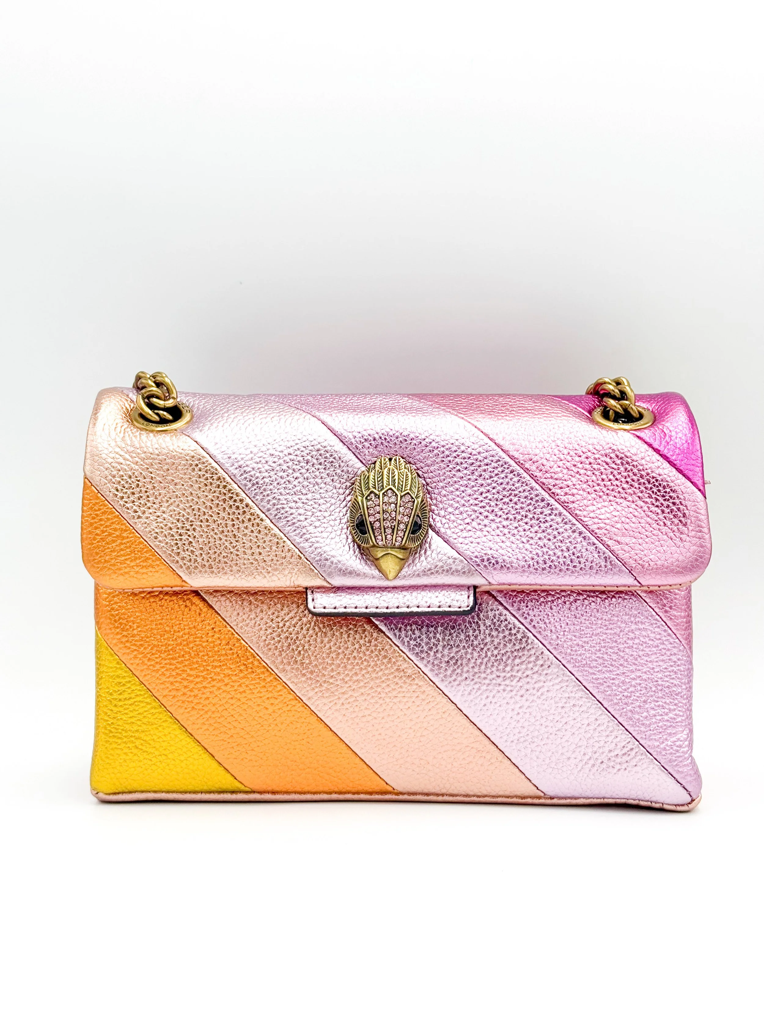Colorful striped handbag with pink, orange, yellow, and pink hues, gold chain strap, and decorative gold clasp with a bird design.