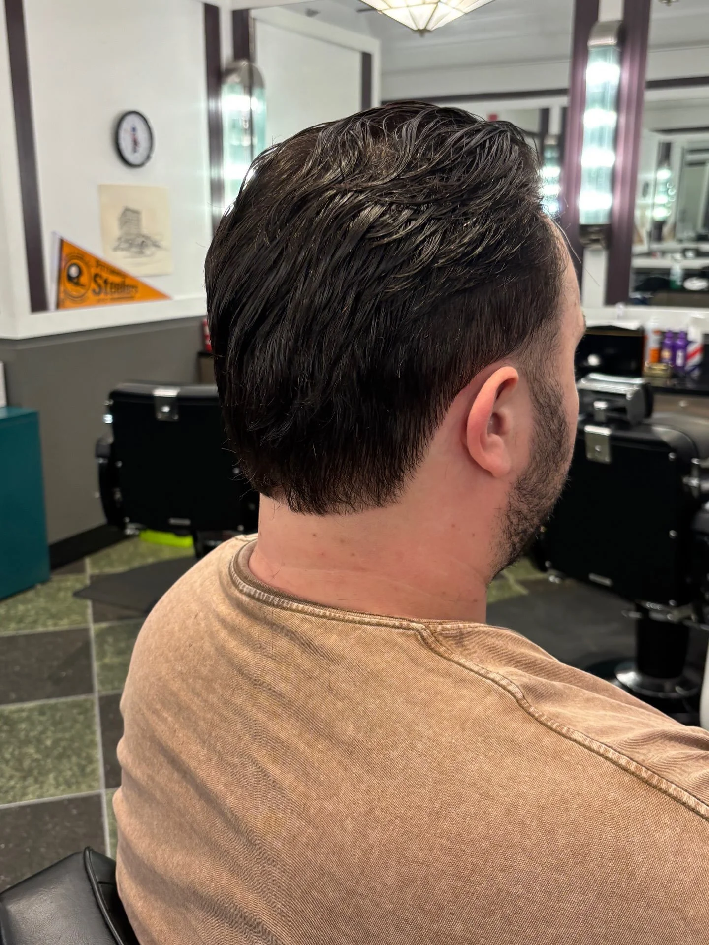 Longer textured haircut with a tapered neckline at Golden Triangle Barber Shop