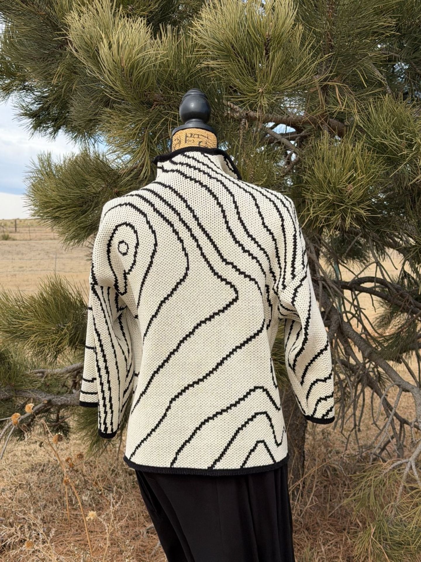 Grand Teton Cartography jacket in natural and black cotton, back view, featuring topographic contour lines.