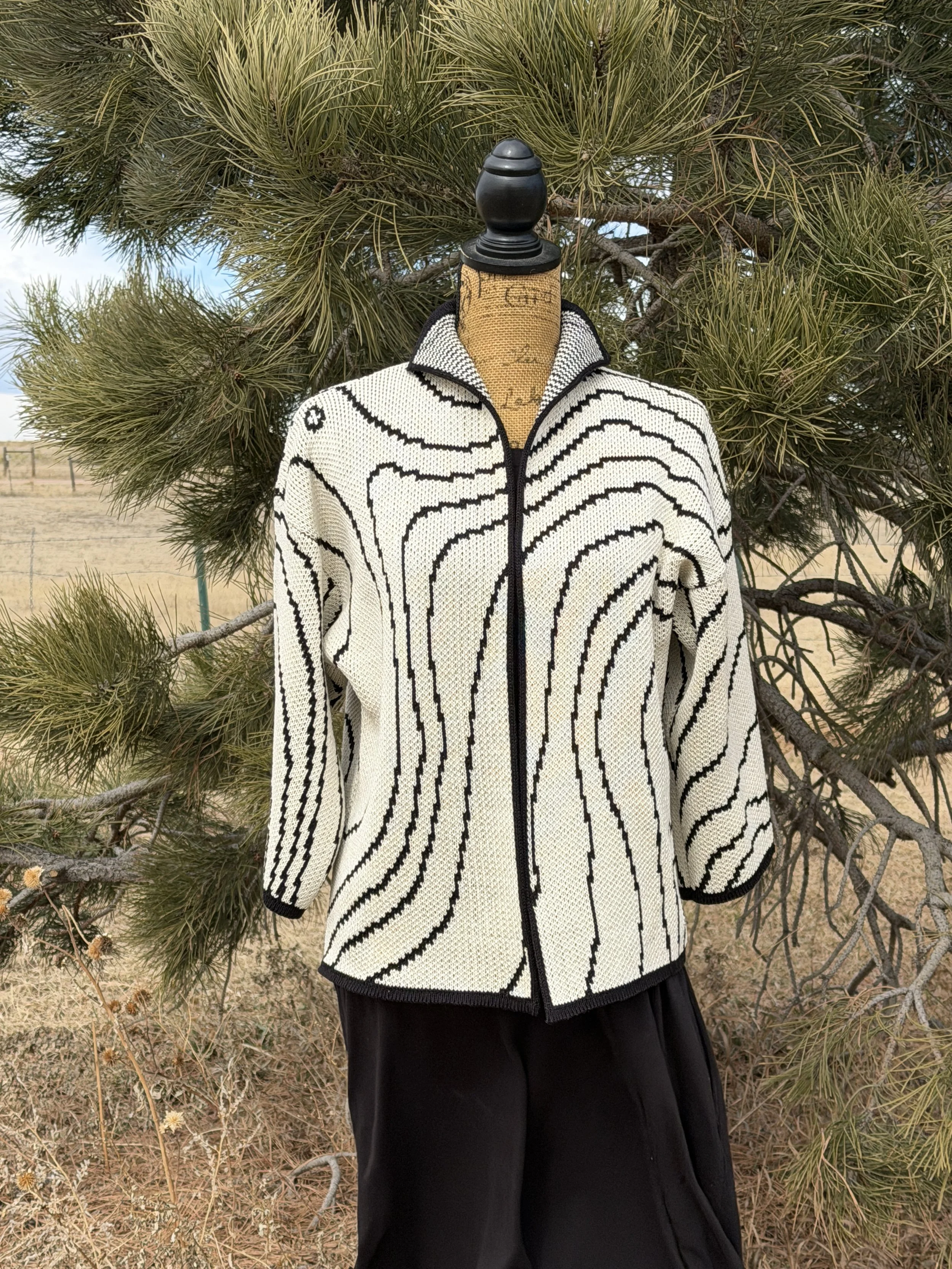 Grand Teton Cartography jacket in natural and black cotton, front view, featuring topographic contour lines.