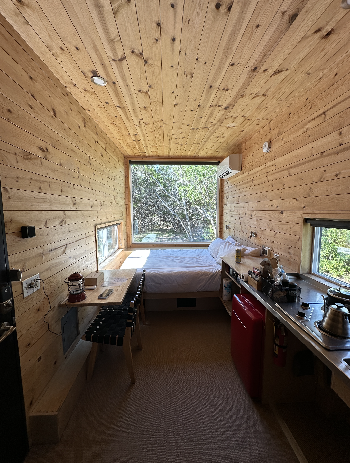 View of the bed and a large picture window