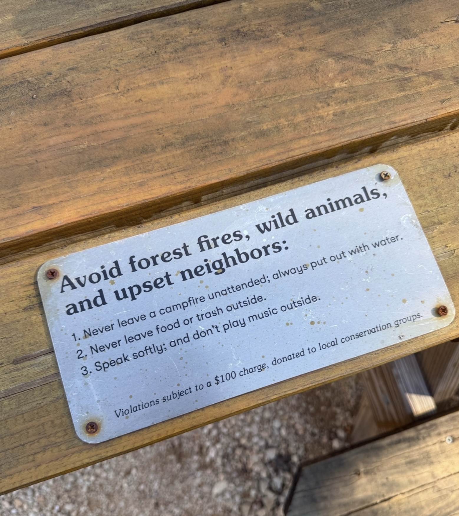 Sign on the picnic table
