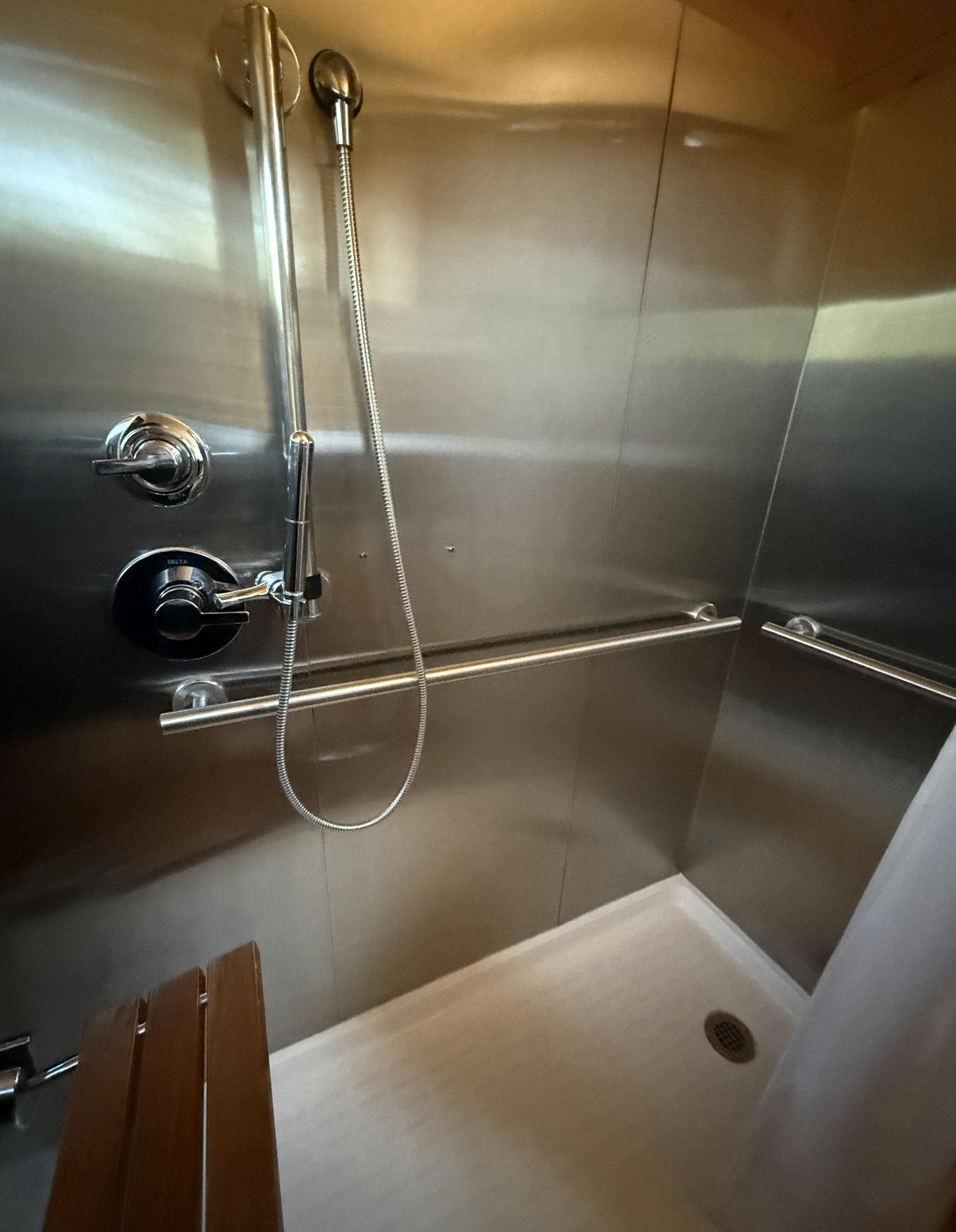 Shower with a small seat on the left side