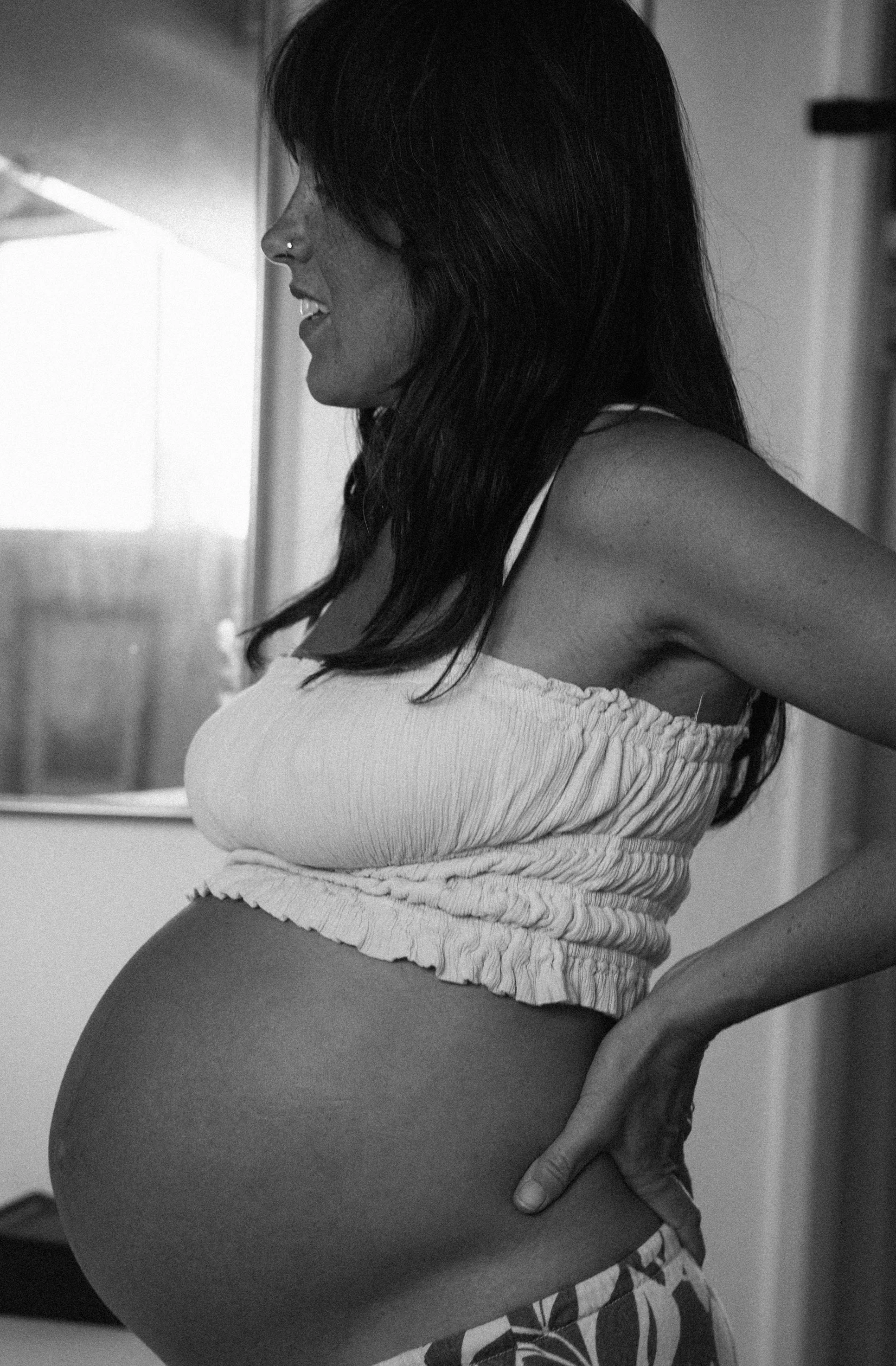 Very pregnant woman black and white
