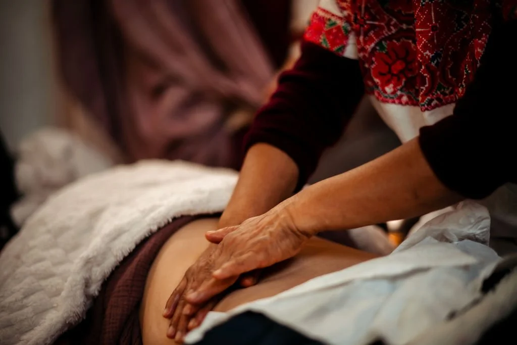 Angelina Miranda Martinez giving womb massage in a closing of the bones class