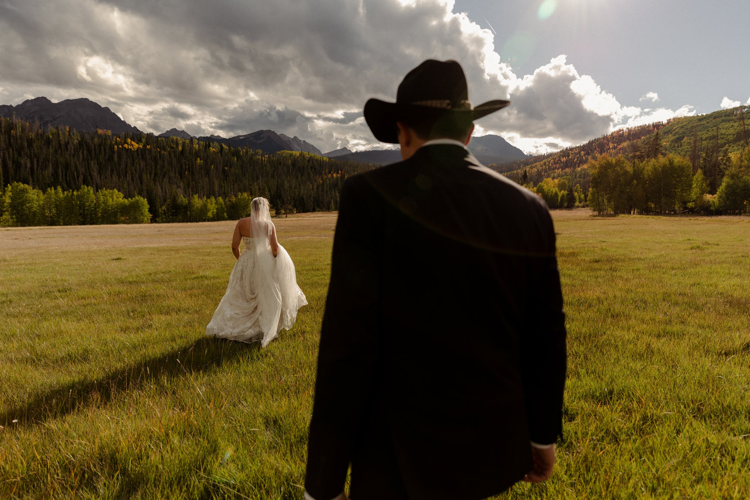 Couple walking in mountains of Silverthorne Colorado at their wedding.