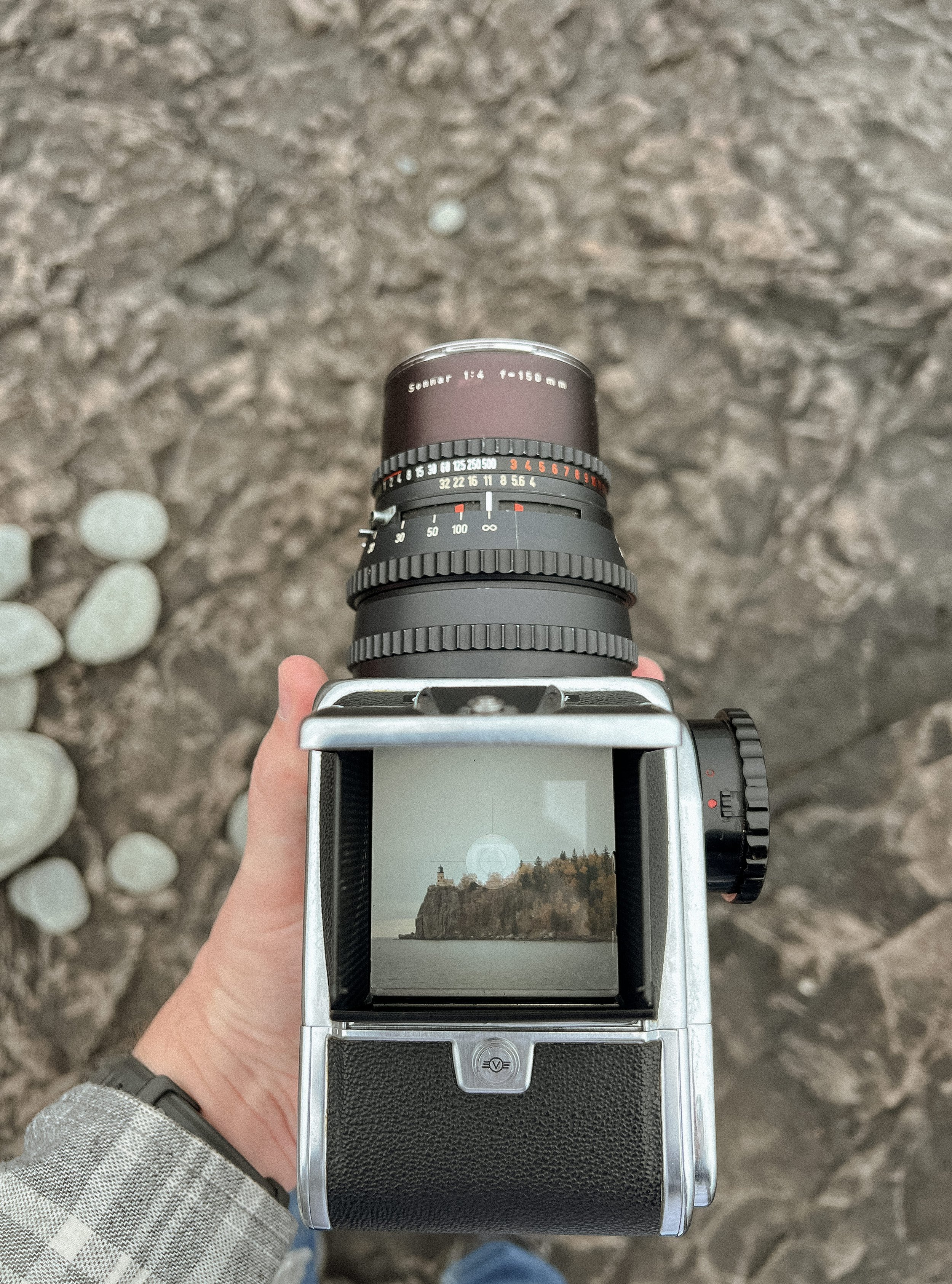 Joey Trcka intimate wedding photographer taking film photo of Split Rock Lighthouse along Minnesota's North Shore.