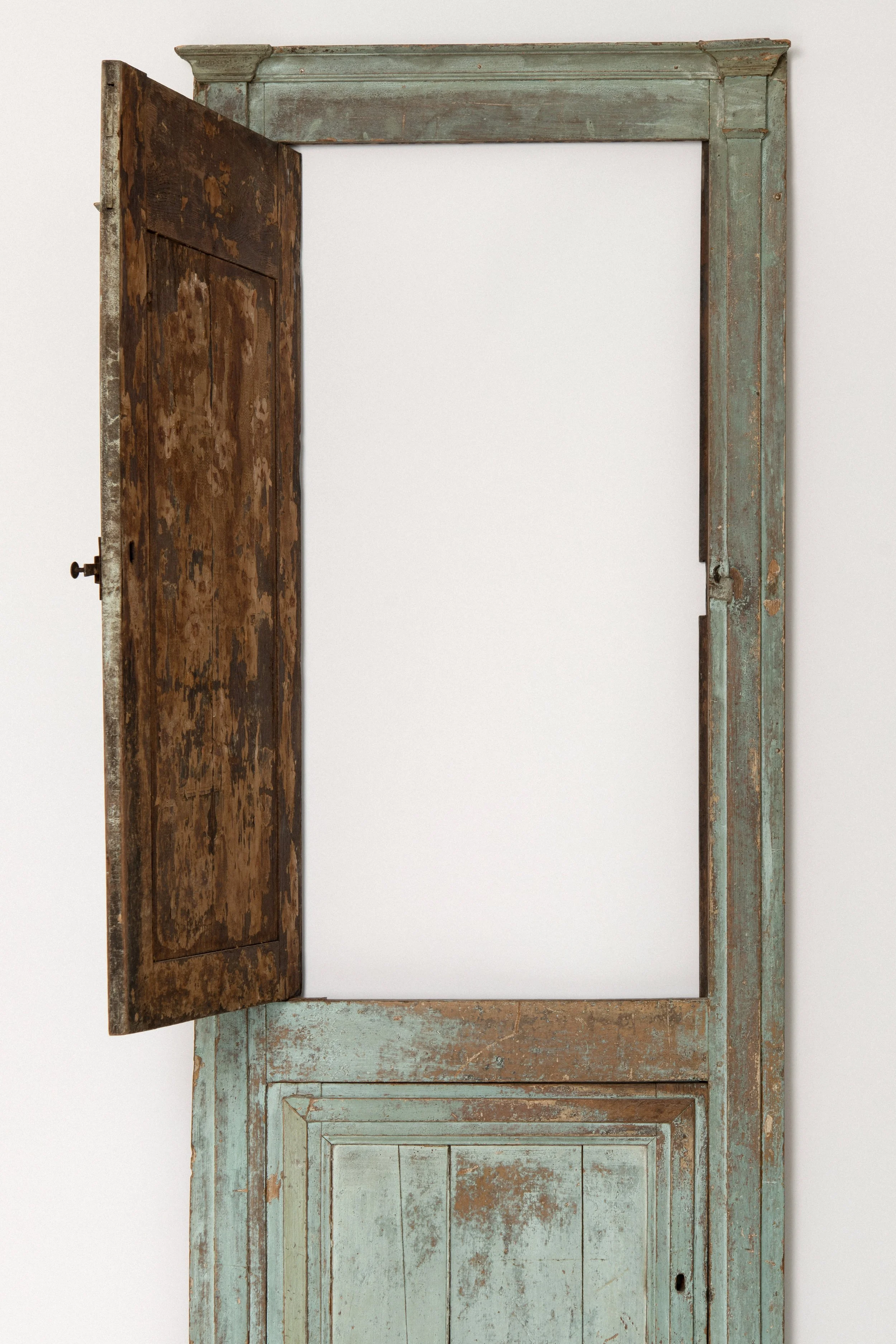 Detail of original verdigris paint on an 18th century New England cupboard front