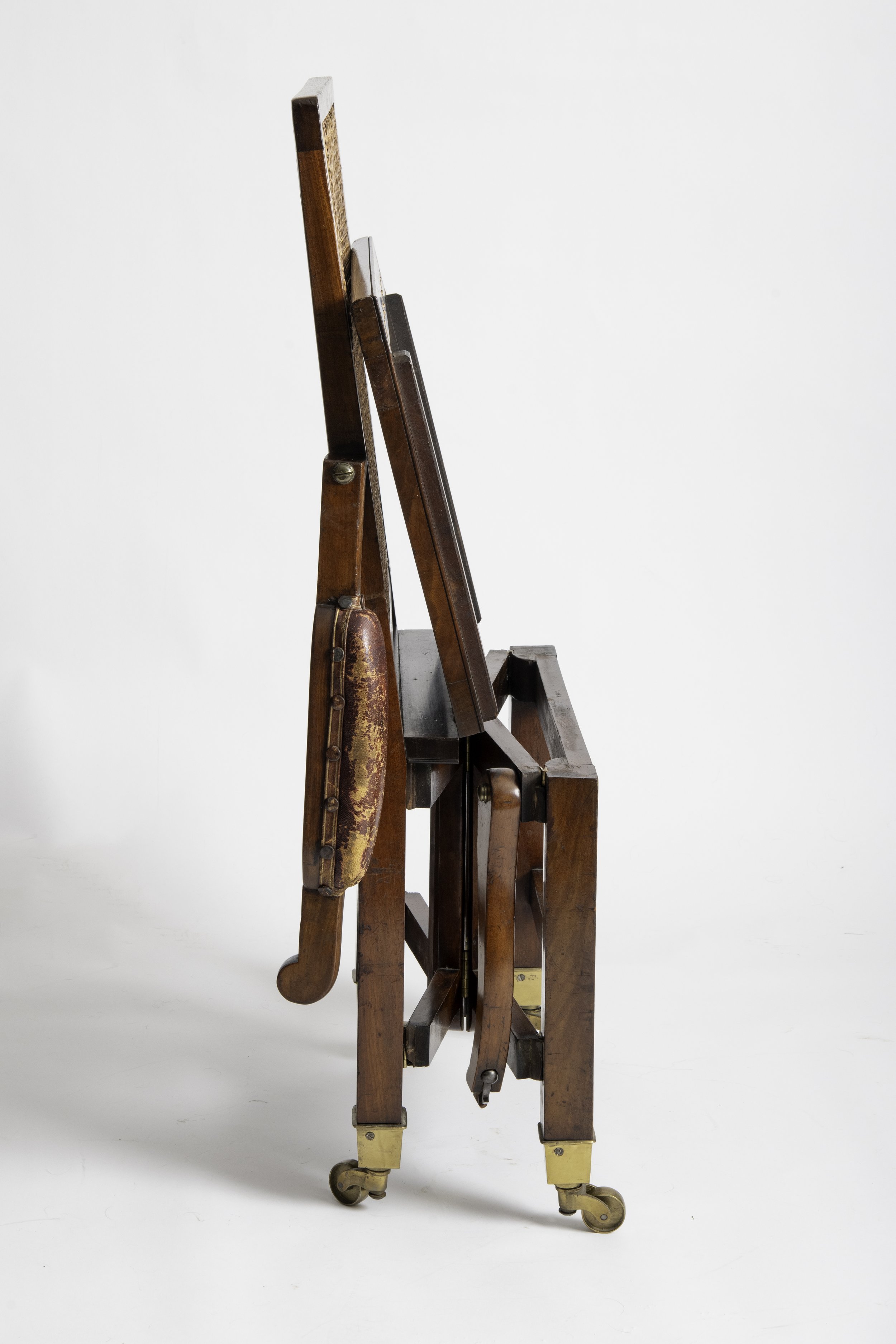 Metamorphic campaign armchair folded into its concertina configuration