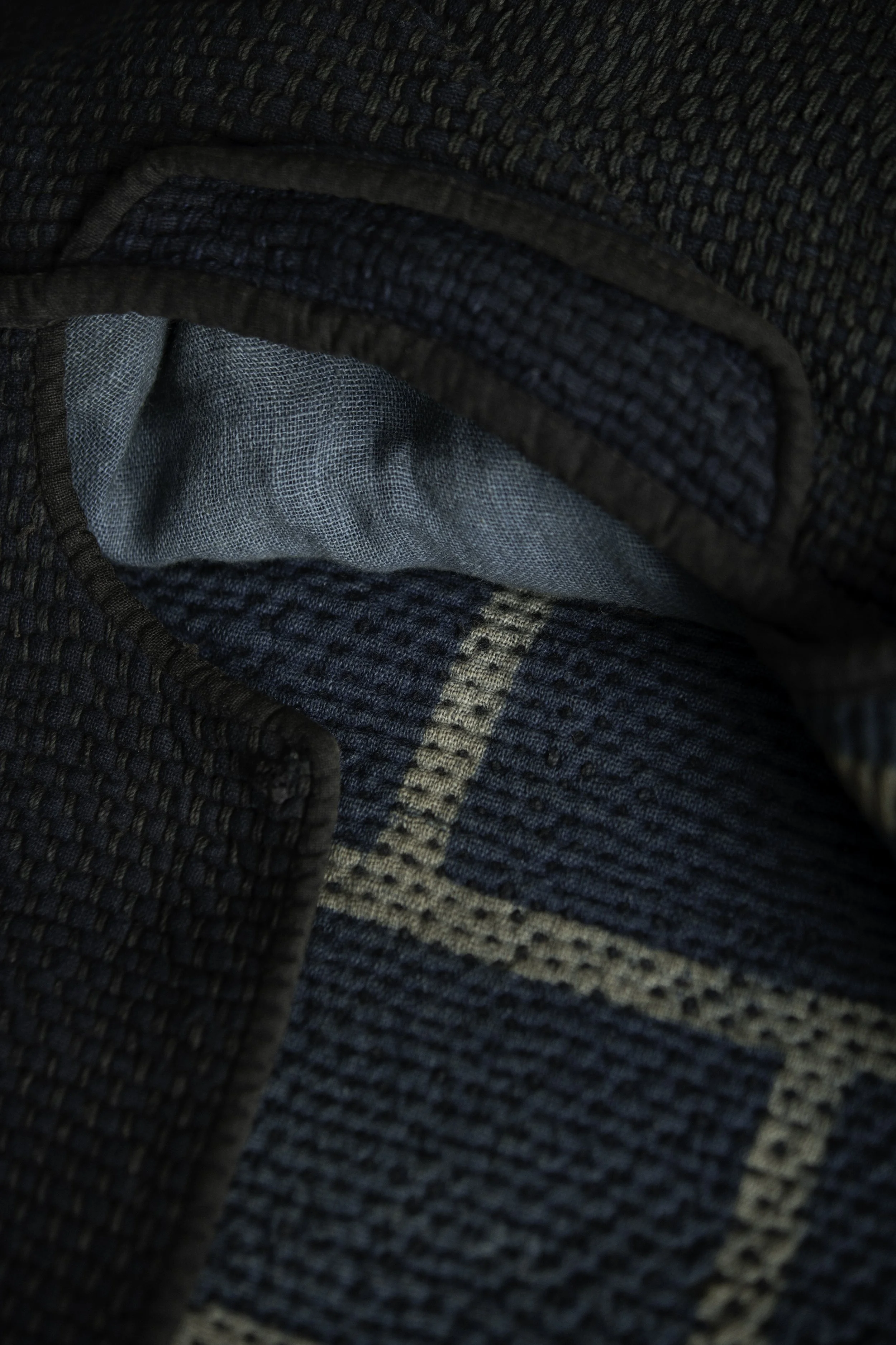 Detail of the interior construction with layered indigo textile reinforcements and sashiko quilting.