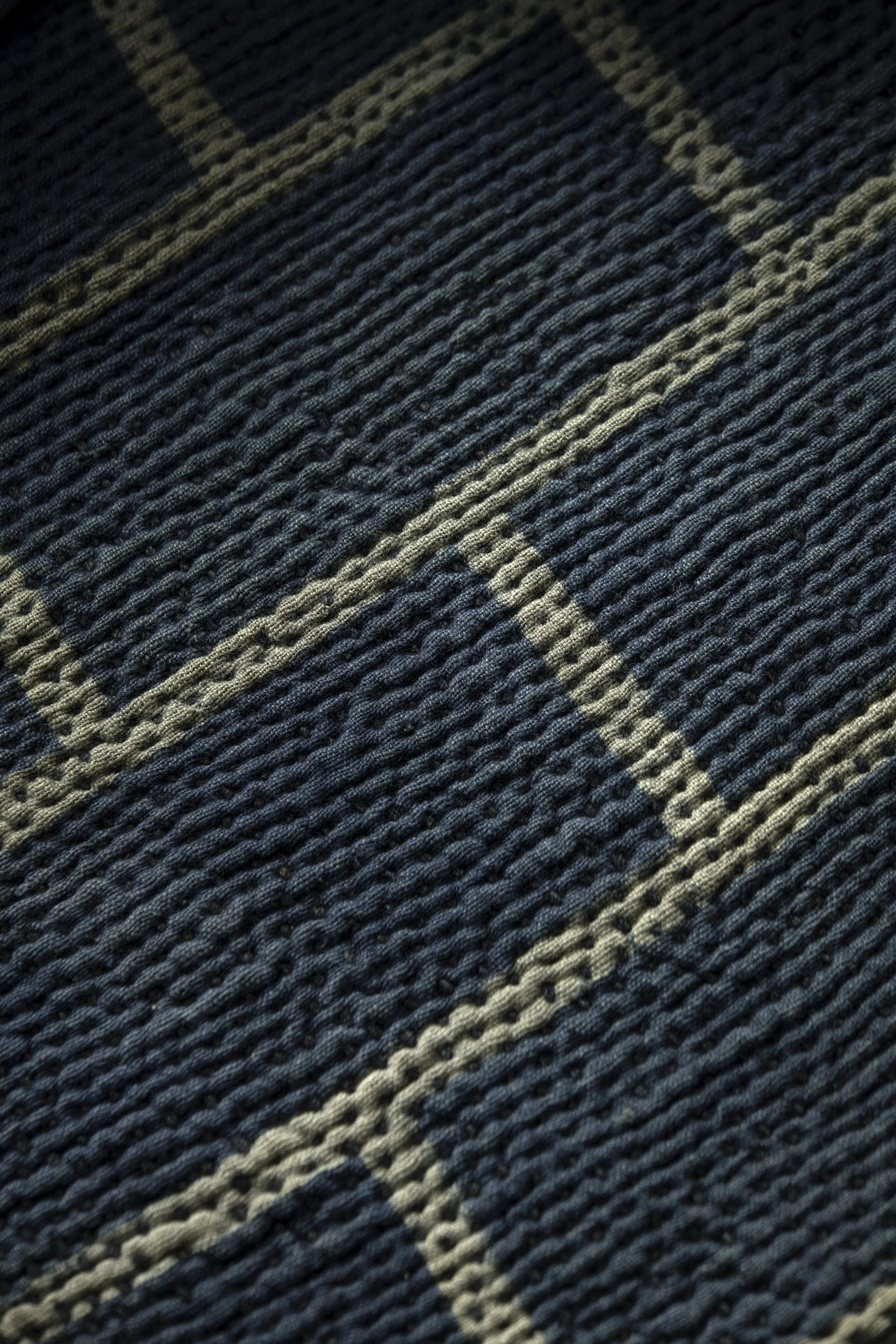 Detail of the interior construction with layered indigo textile reinforcements and sashiko quilting.