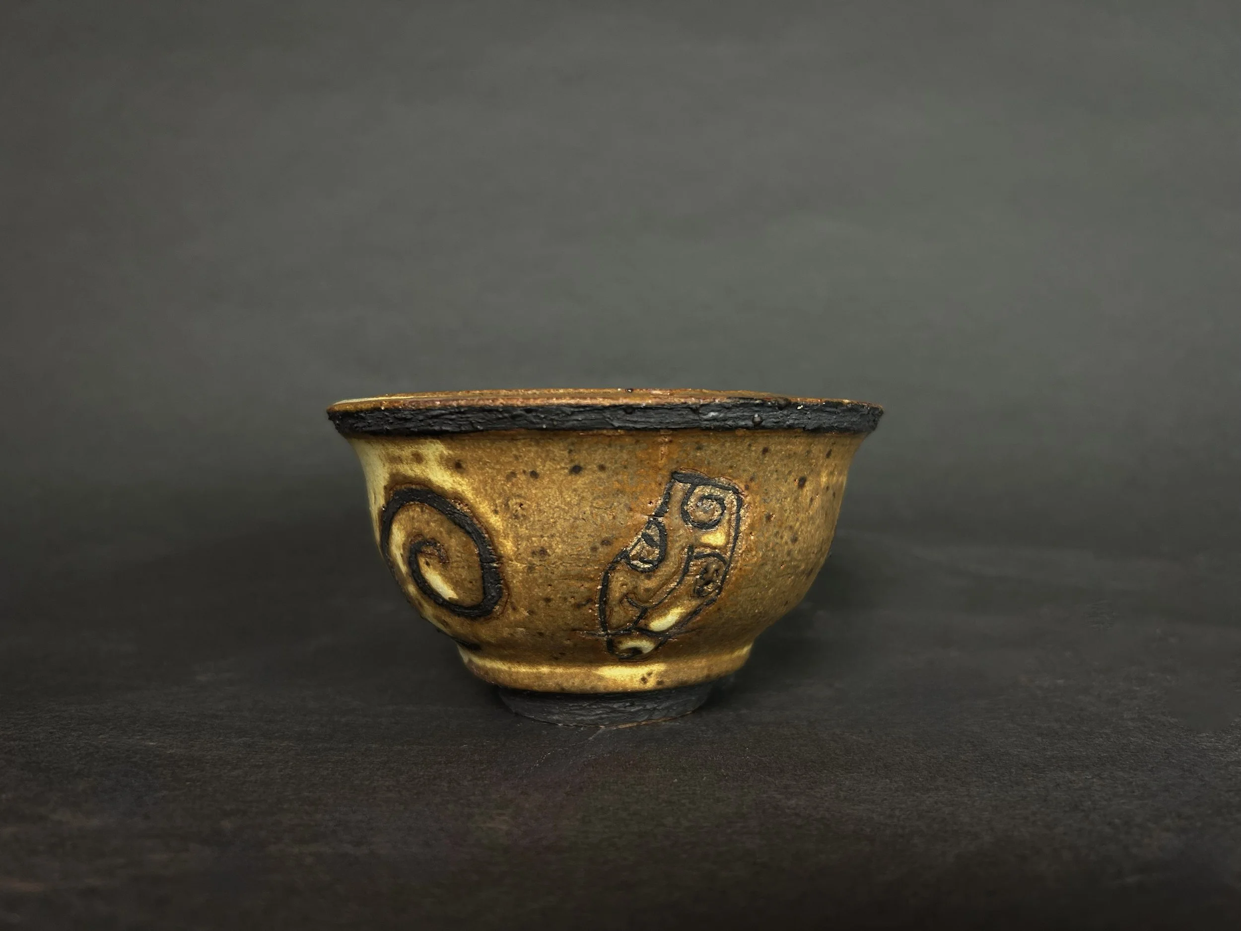 'swirl about it' teacup - Yellow salt high fire glaze, black slip