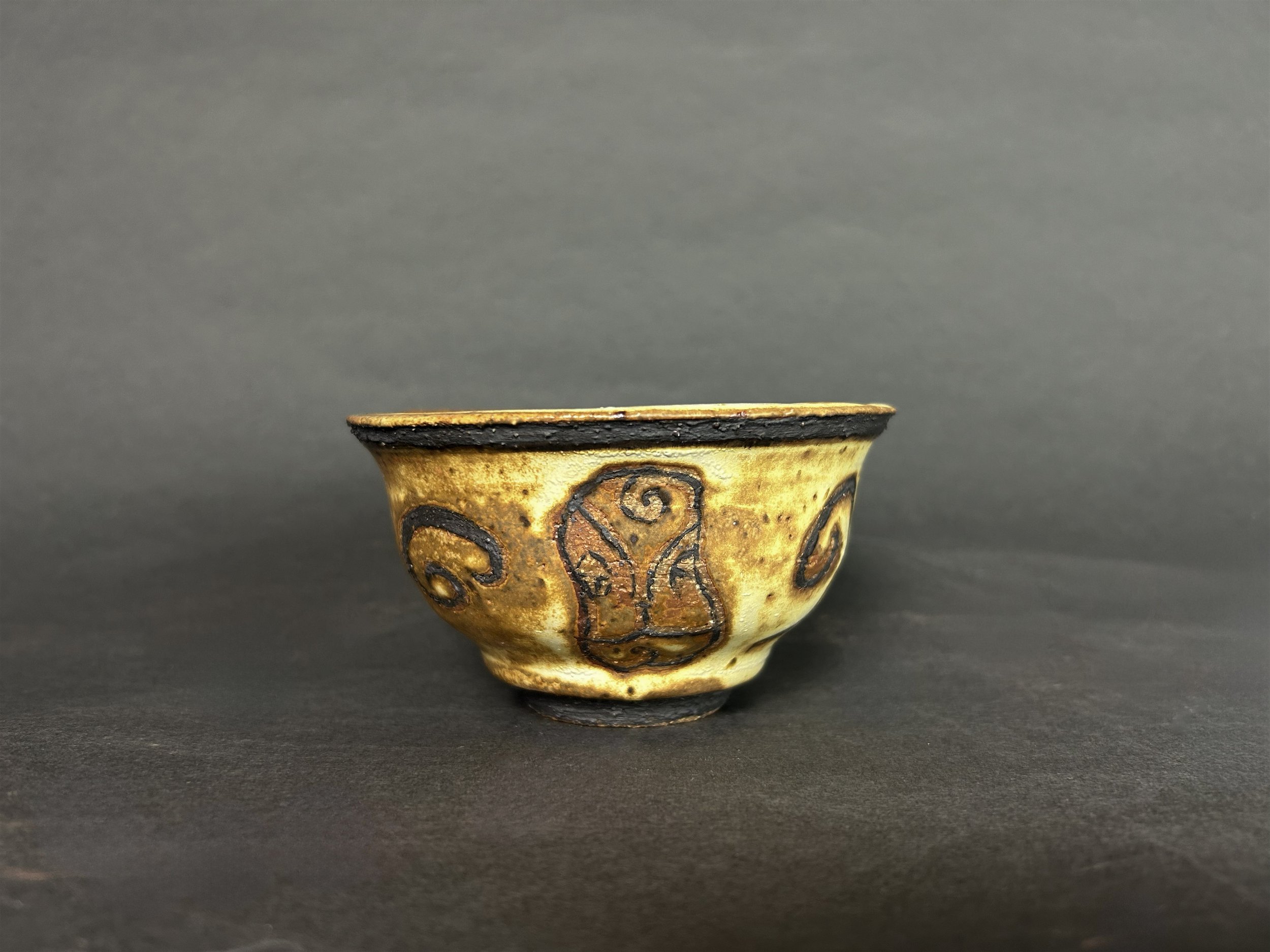 'swirl about it' teacup - Yellow salt high fire glaze, black slip
