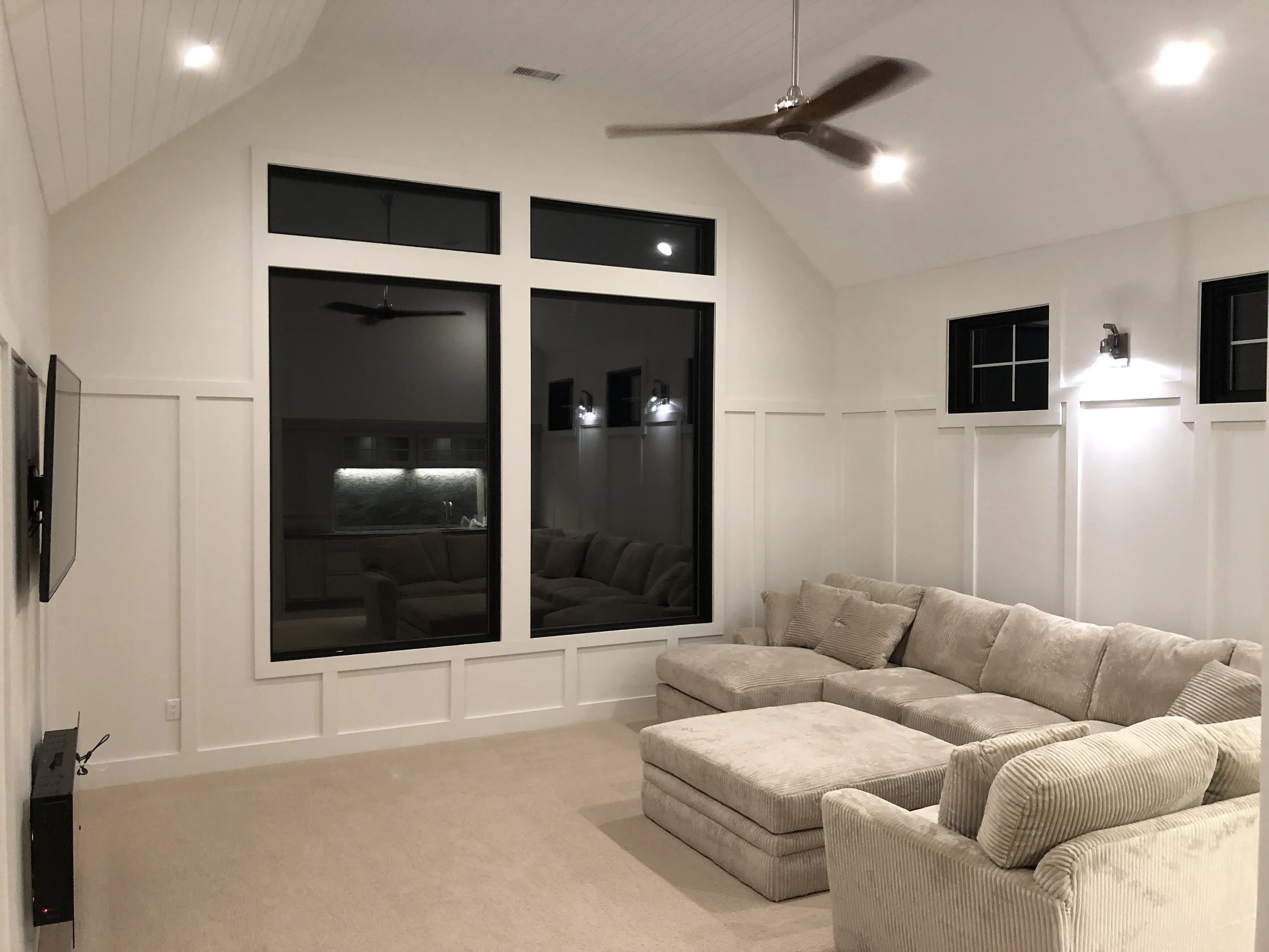 Image of completed Glen Holman Contracting addition viewed from interior with large picture windows and detailed wall and ceiling trim.