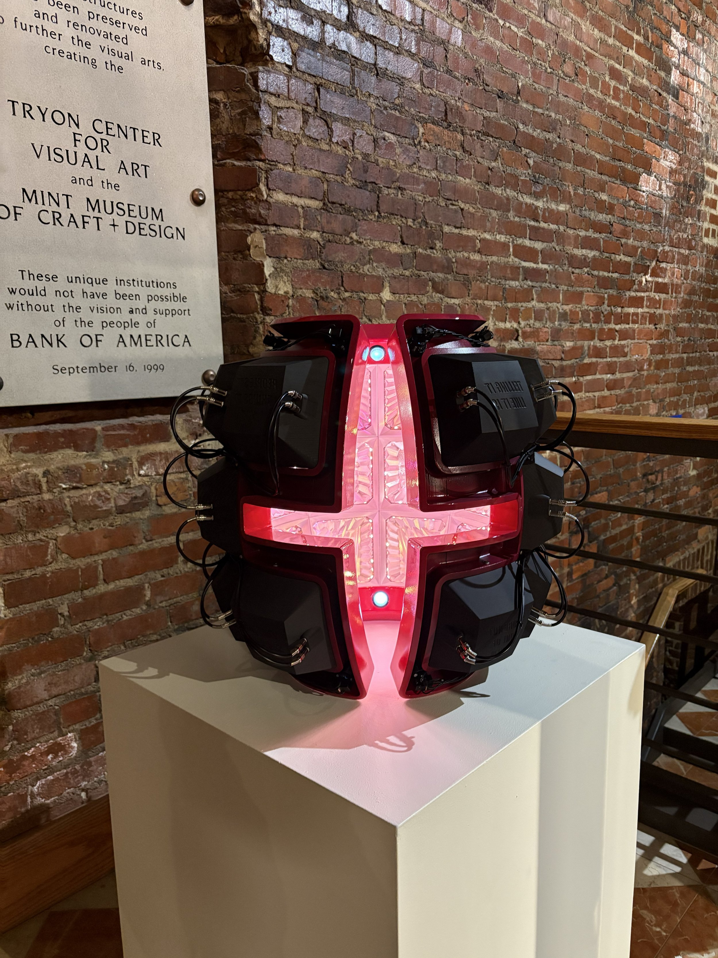 PINK SHELL was displayed in the entryway of the McColl Center, contrasting with the historic brick interior of the building.