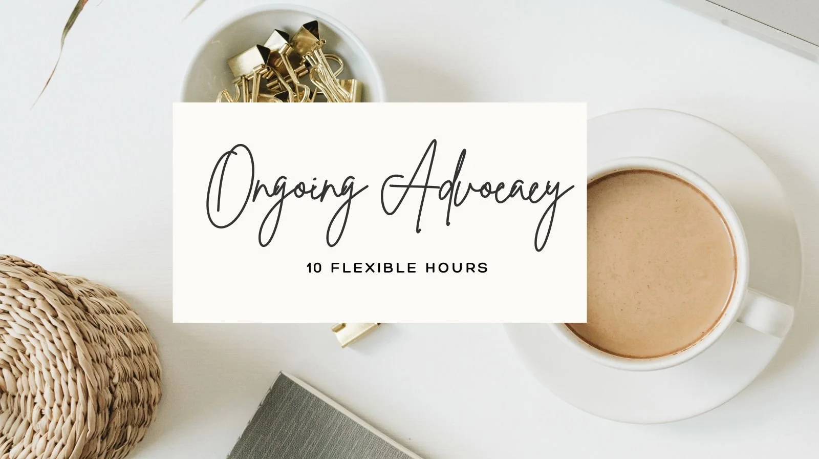 A white coffee cup filled with coffee on a saucer, a woven basket, a gray notebook, and a white bowl with gold binder clips on a white table.