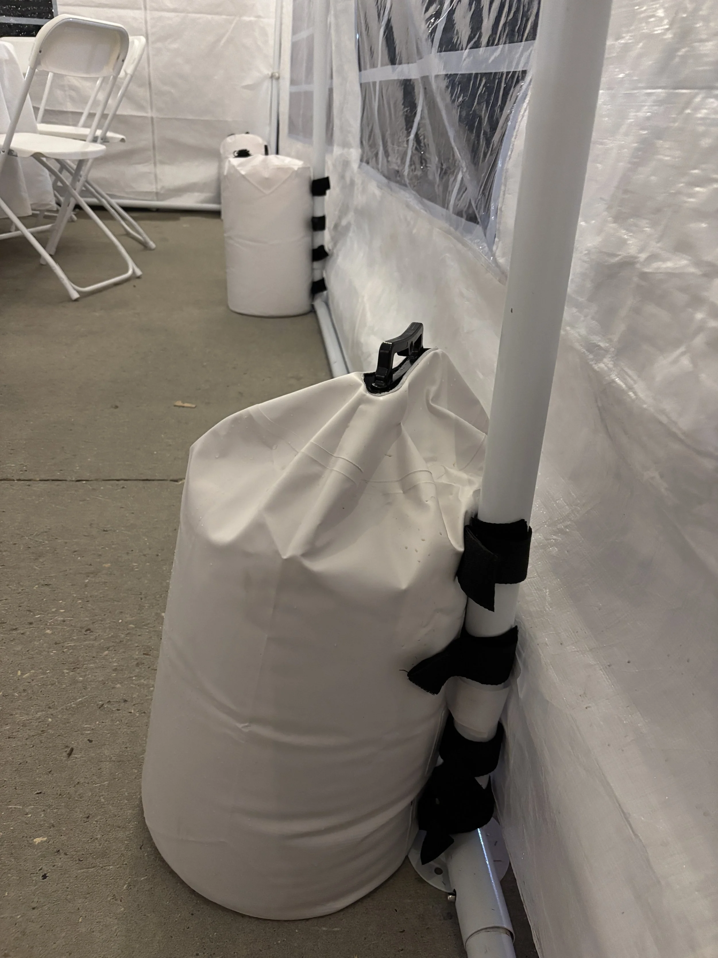 Water bags to hold down tent on concrete.