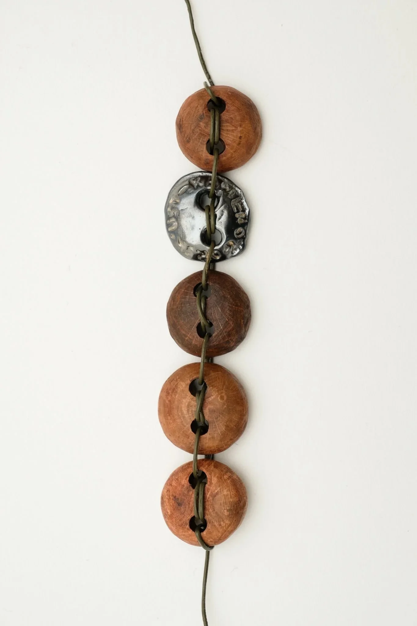Bracelet 'Made In_' 
Bracelet, wood, silver, leather cord 
