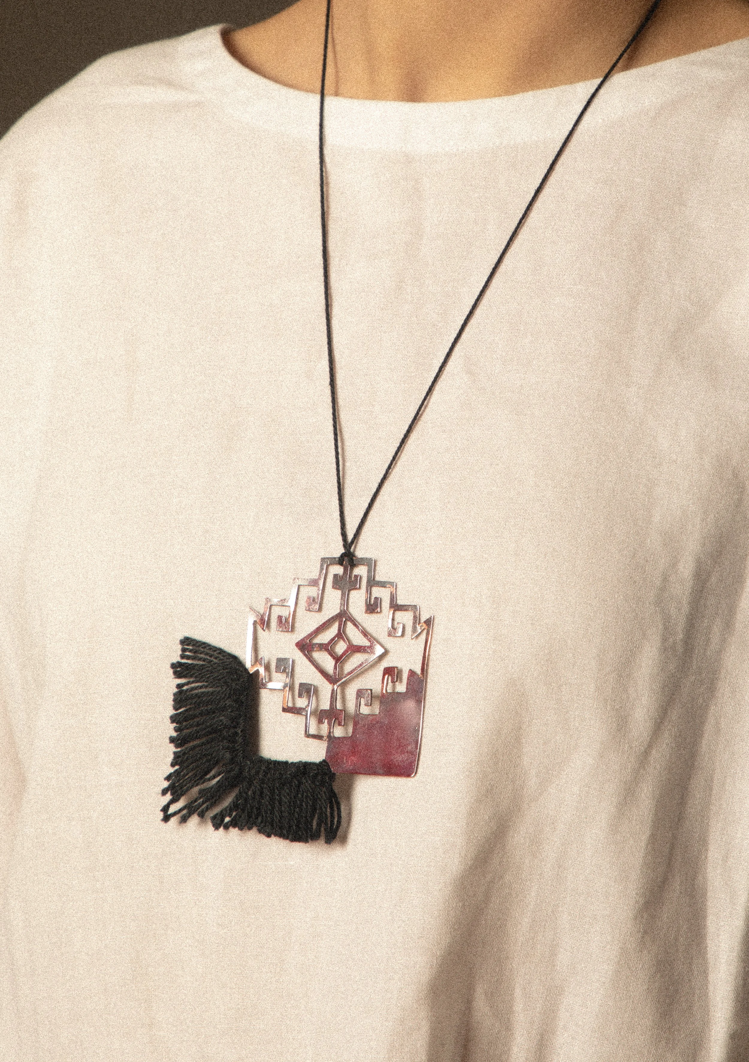 Khali Necklace. 

The necklace elevates one of the main carpet designs in the photographs. 
Materials: Copper, cotton string