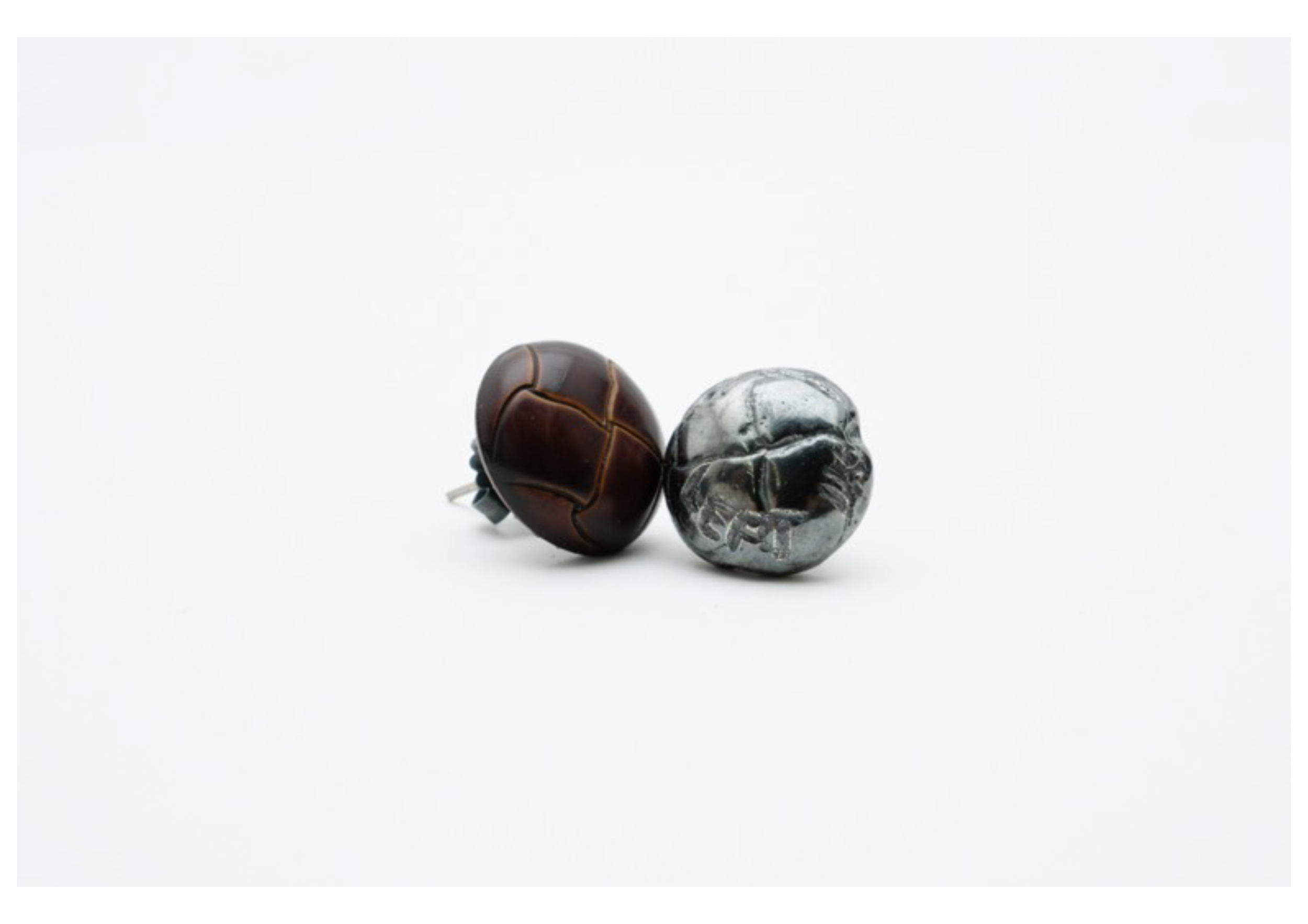 The earrings follow the same ghostly tribute to a missing button, replicating it in precious metal and transforming the original into a stud. Left In_ reflects on buttons and memory objects left behind, fragmented and incomplete, now given a second l