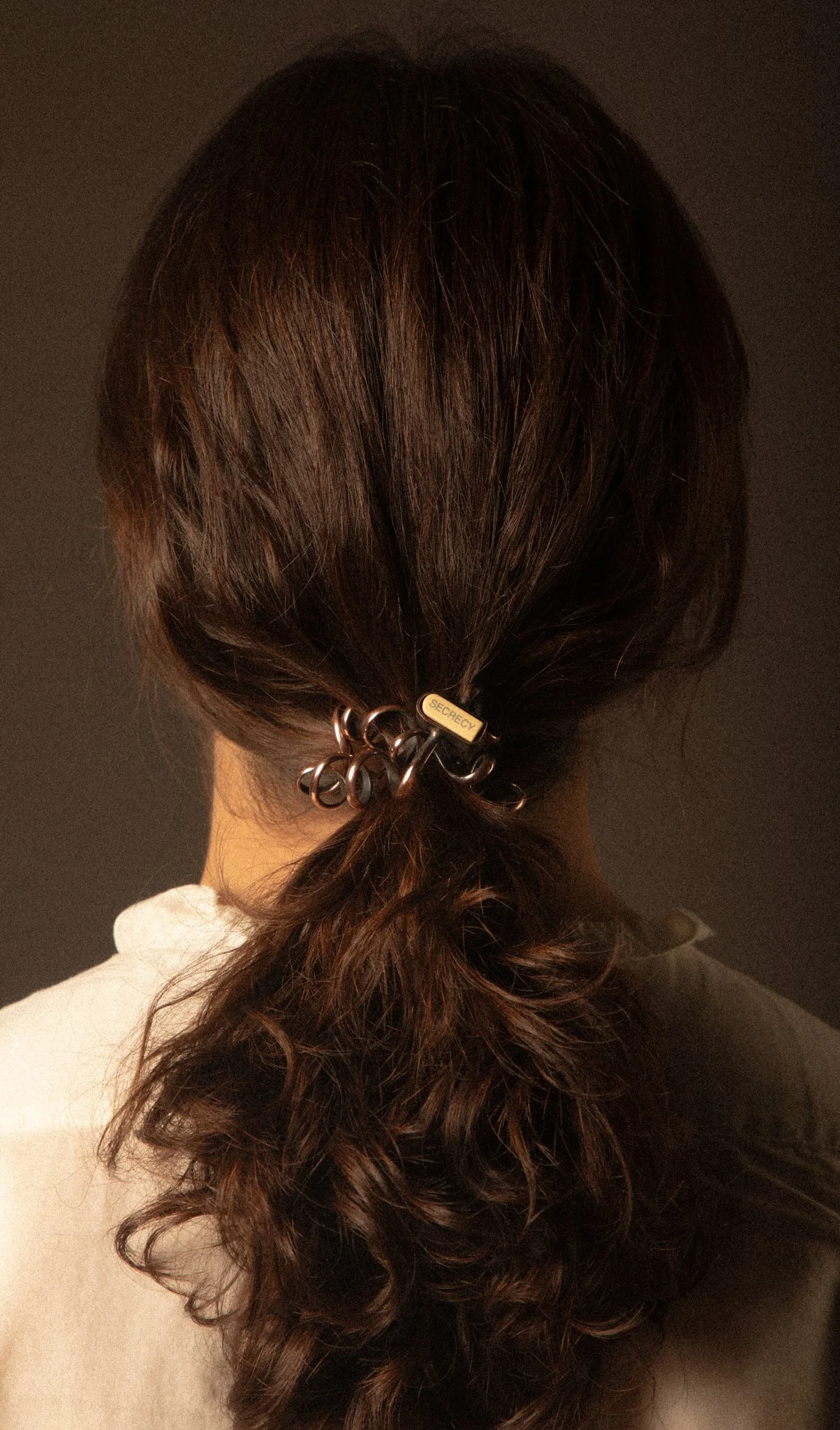 Drawing from the way telephone wires once connected us physically during conversations, ’Muting The Call’ captures that playful yet intimate interaction, this time woven through the hair, making it a lasting presence.
Materials: copper, plastic