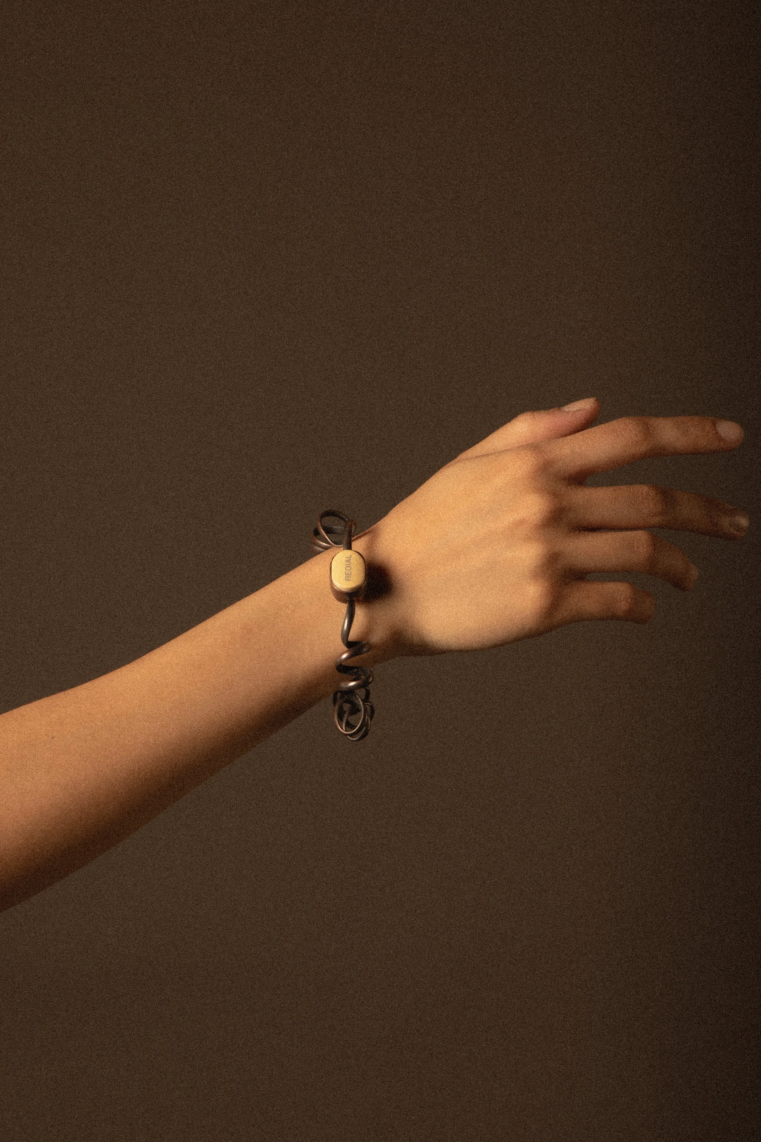 The Redial bracelet mirrors the aging motion of a worn-out telephone wire, flexible yet increasingly difficult to control as it stretches over time.
Materials: copper, plastic