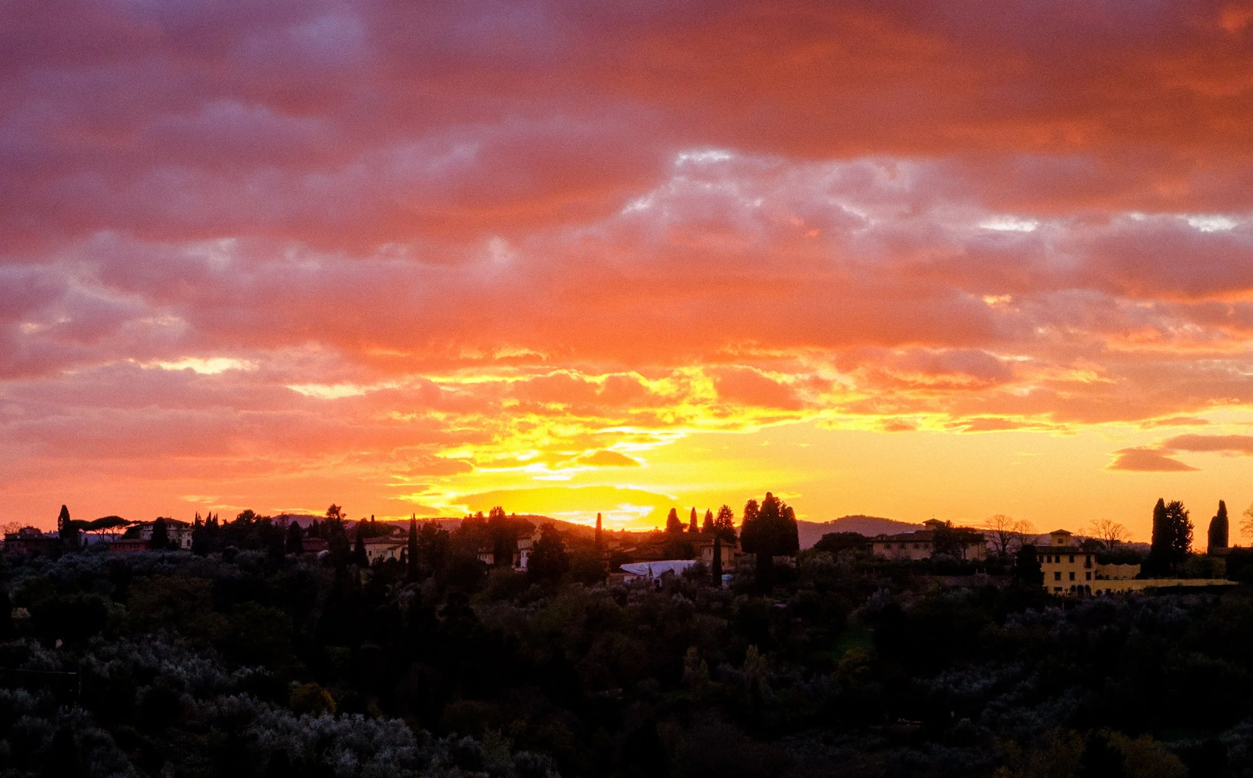 Dramatic sunset over the Tuscan landscape surrounding Florence