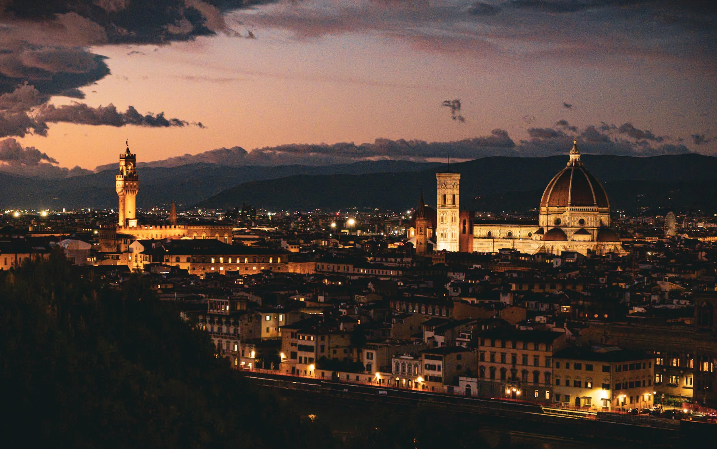 Florence skyline at night with the illuminated Duomo and Palazzo Vecchio