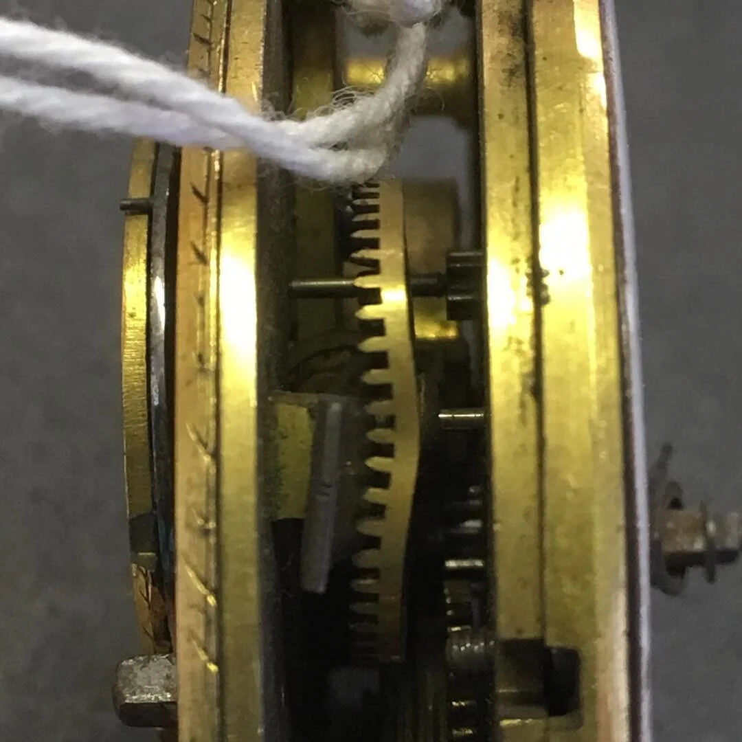 An image of a pocket watch with a damaged contrate wheel