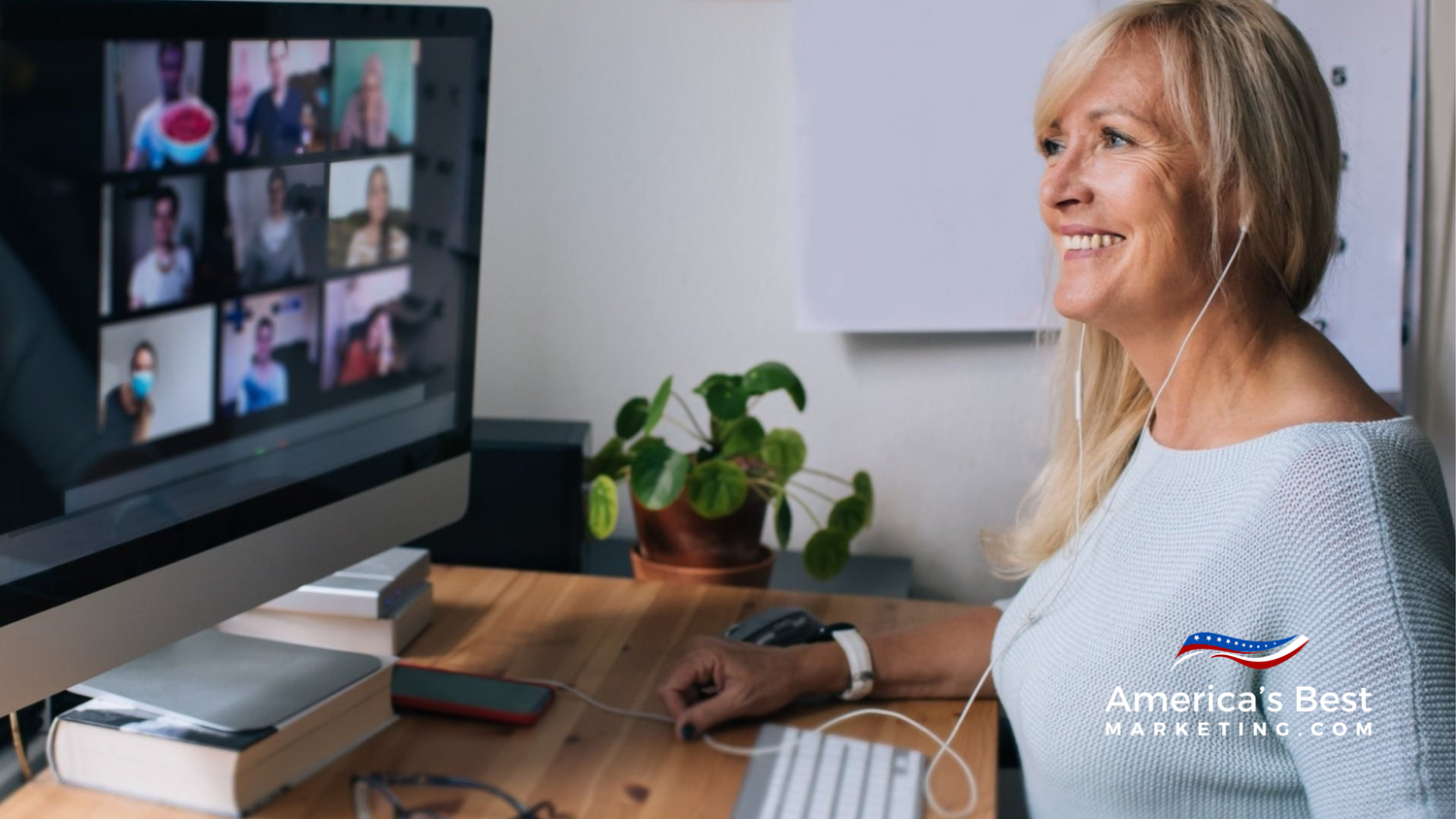 Real estate agent and coach reviewing marketing metrics on laptop during focused strategy session in modern office.