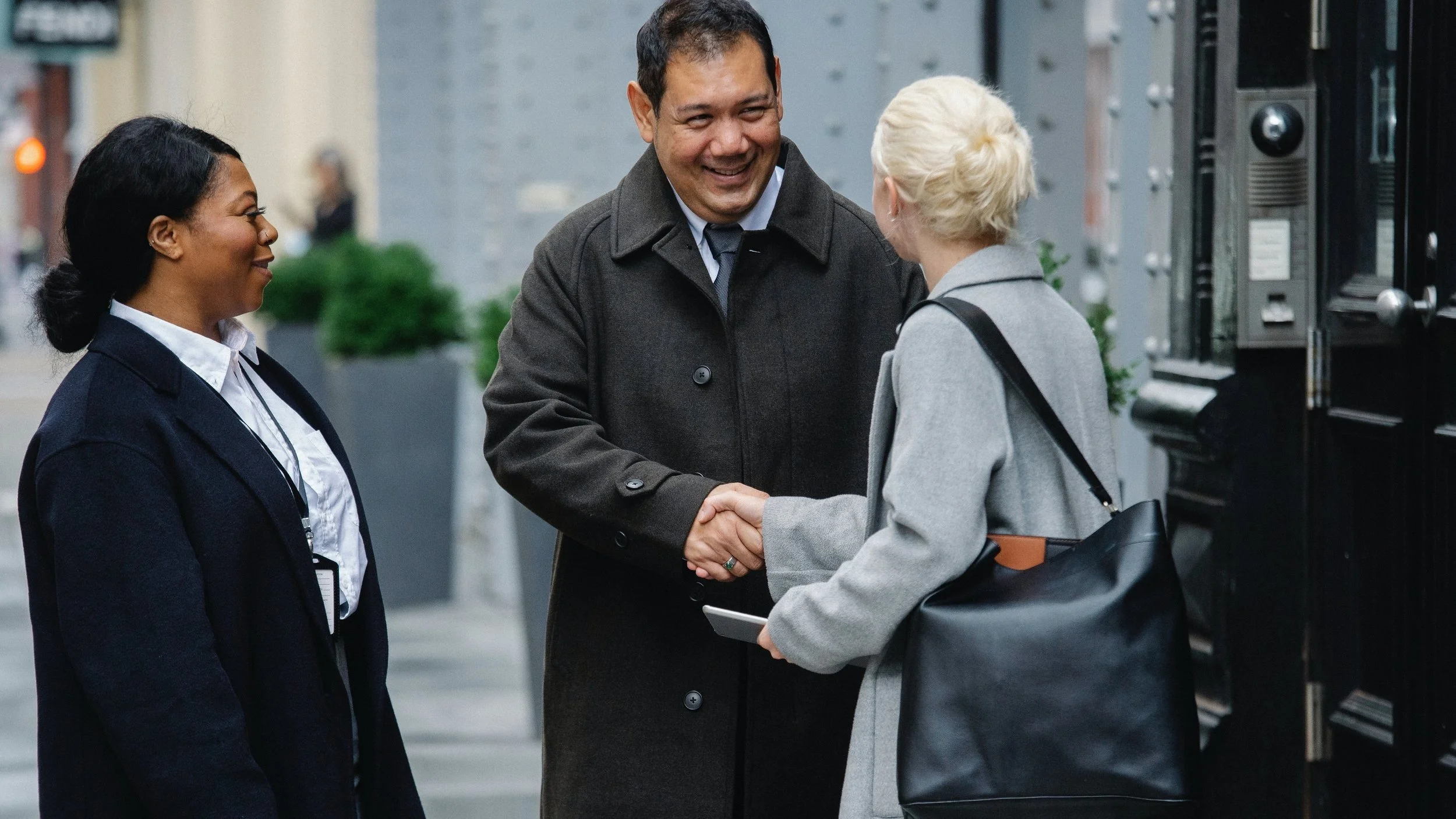 Realtor® shaking hands with a happy client, confidently focused on service thanks to a done-for-you real estate marketing program
