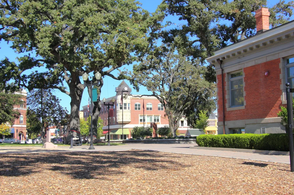 Downtown Paso Robles streetscape with historic buildings framed by oak trees