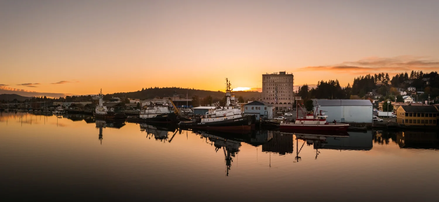 Beautiful orange sunset over Coos Bay, Oregon waterfront in Coos Bay showcasing real estate market opportunities
