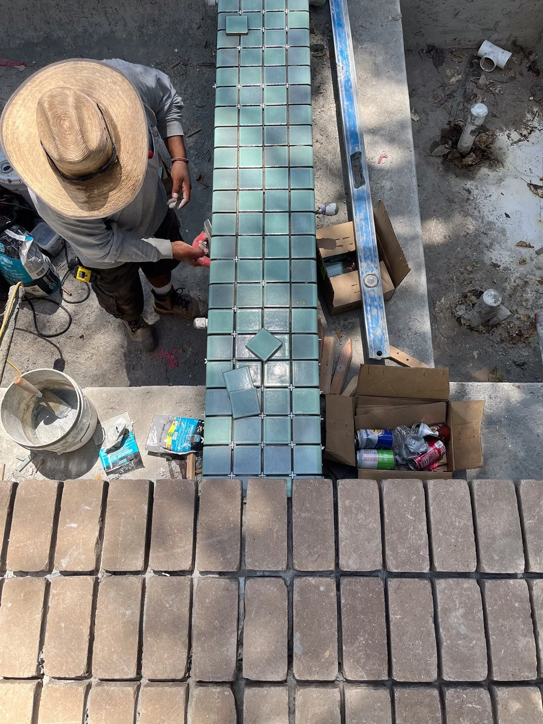 Developing the material transitions and edge details along the pool