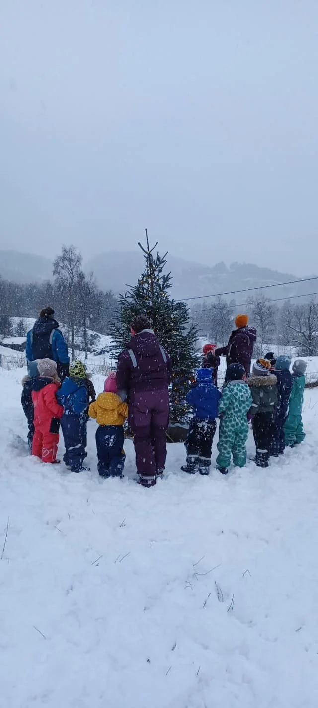 Aadland gards- og friluftsbarnehage som feirer jul med å gå rundt juletre utendørs i snøen