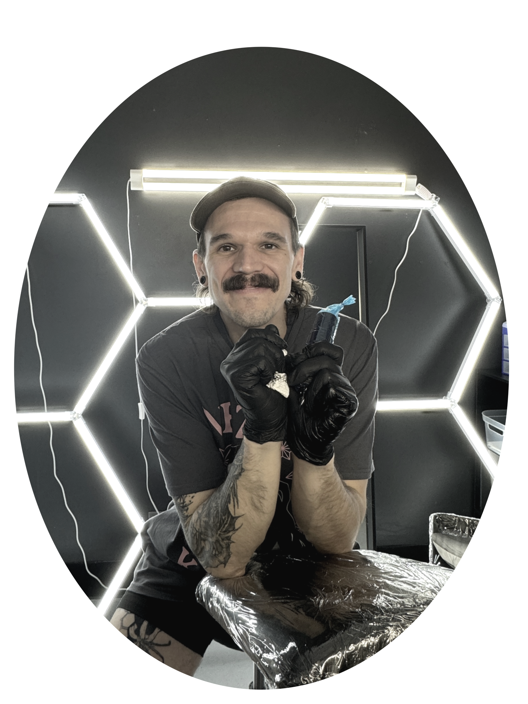 An image of the artist smiling at the camera in the studio. He is very welcoming and has a calm demeanor about him.