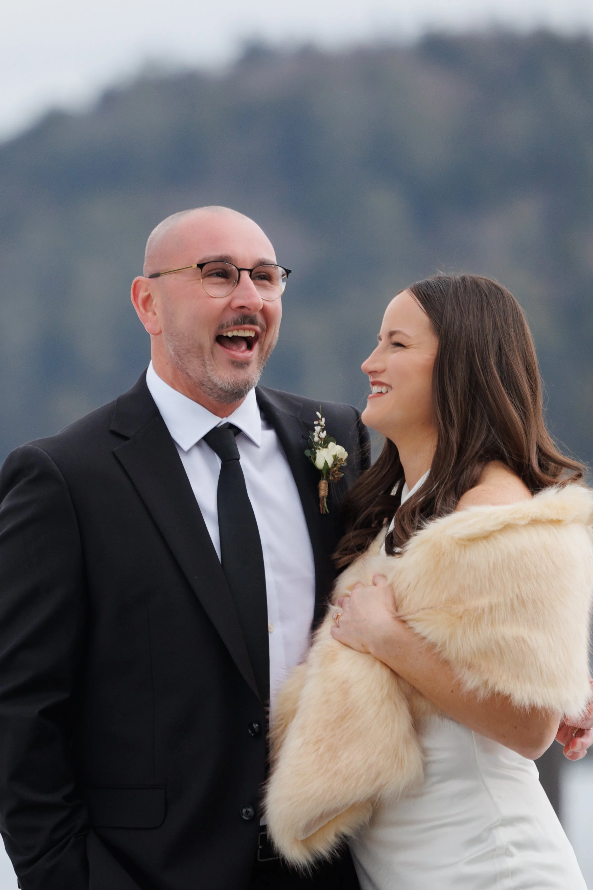Candid moment of bride and groom laughing during Lake Placid Lodge elopement