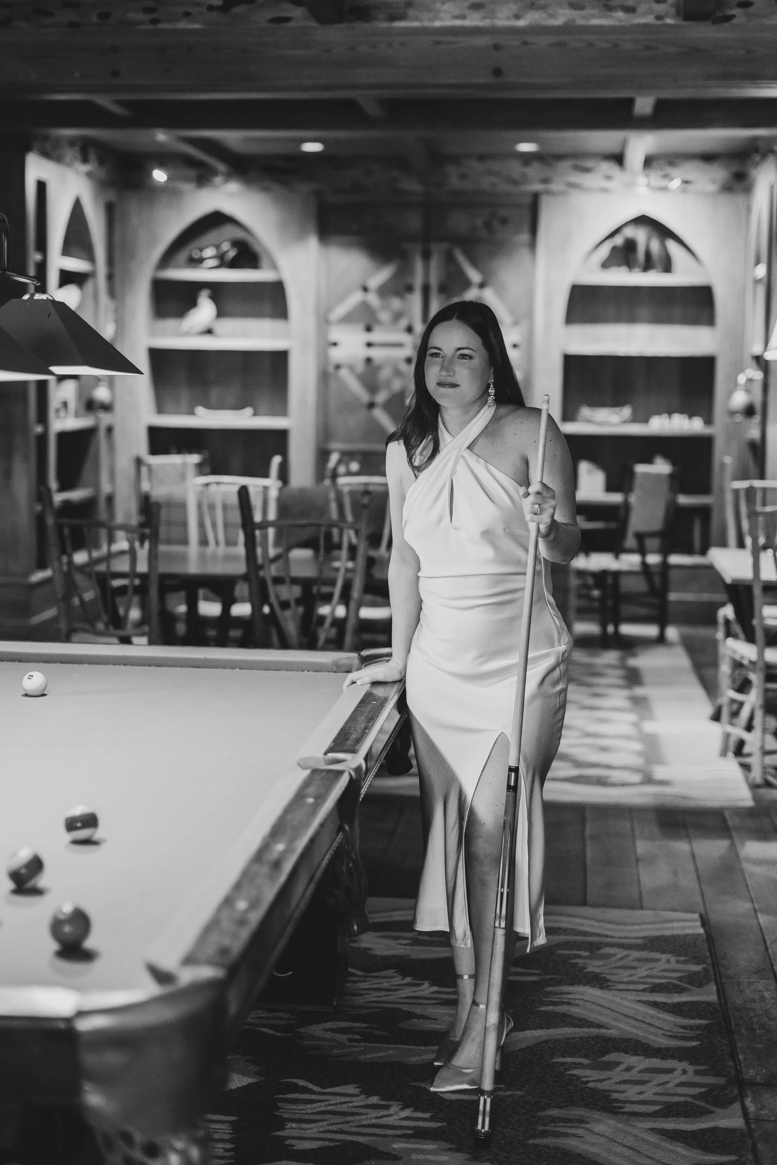 Couple playing pool during their winter elopement at Lake Placid Lodge