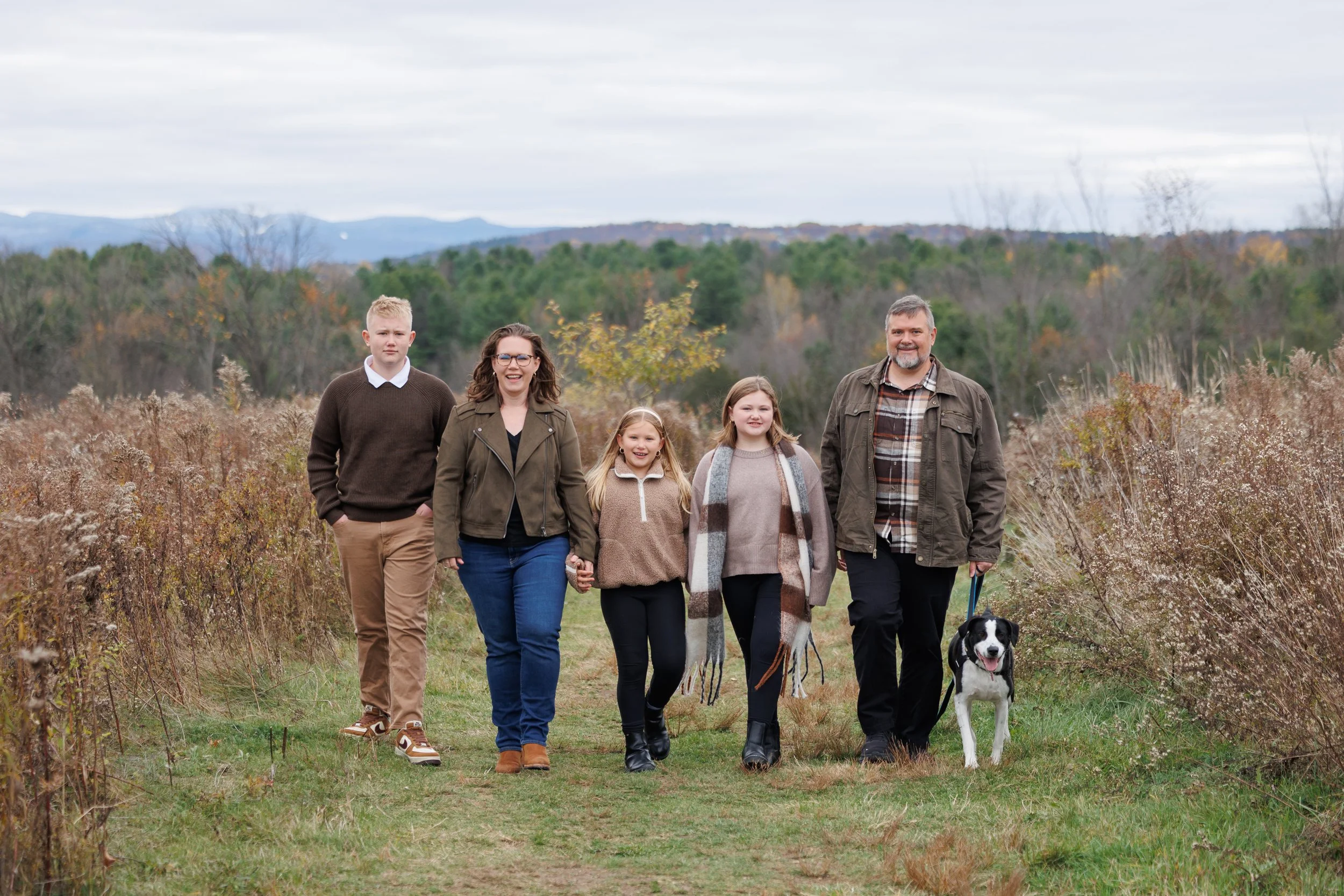 a family and their dog walking through wheeler nature park