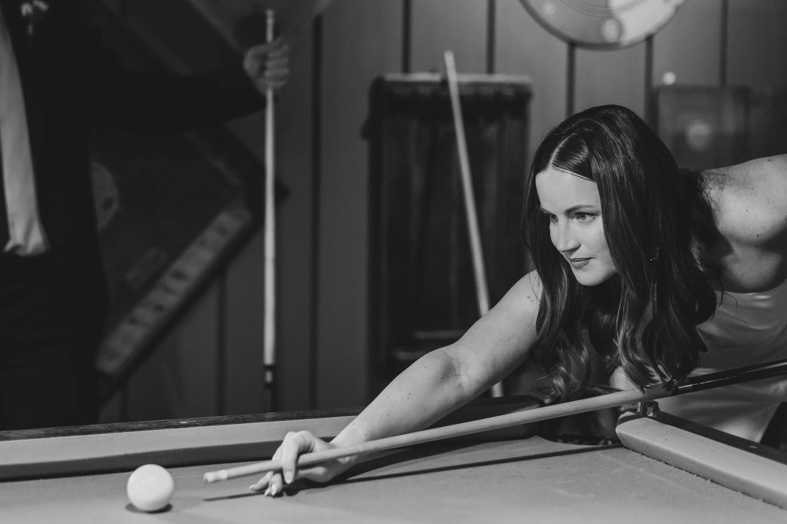 Couple playing pool during their winter elopement at Lake Placid Lodge