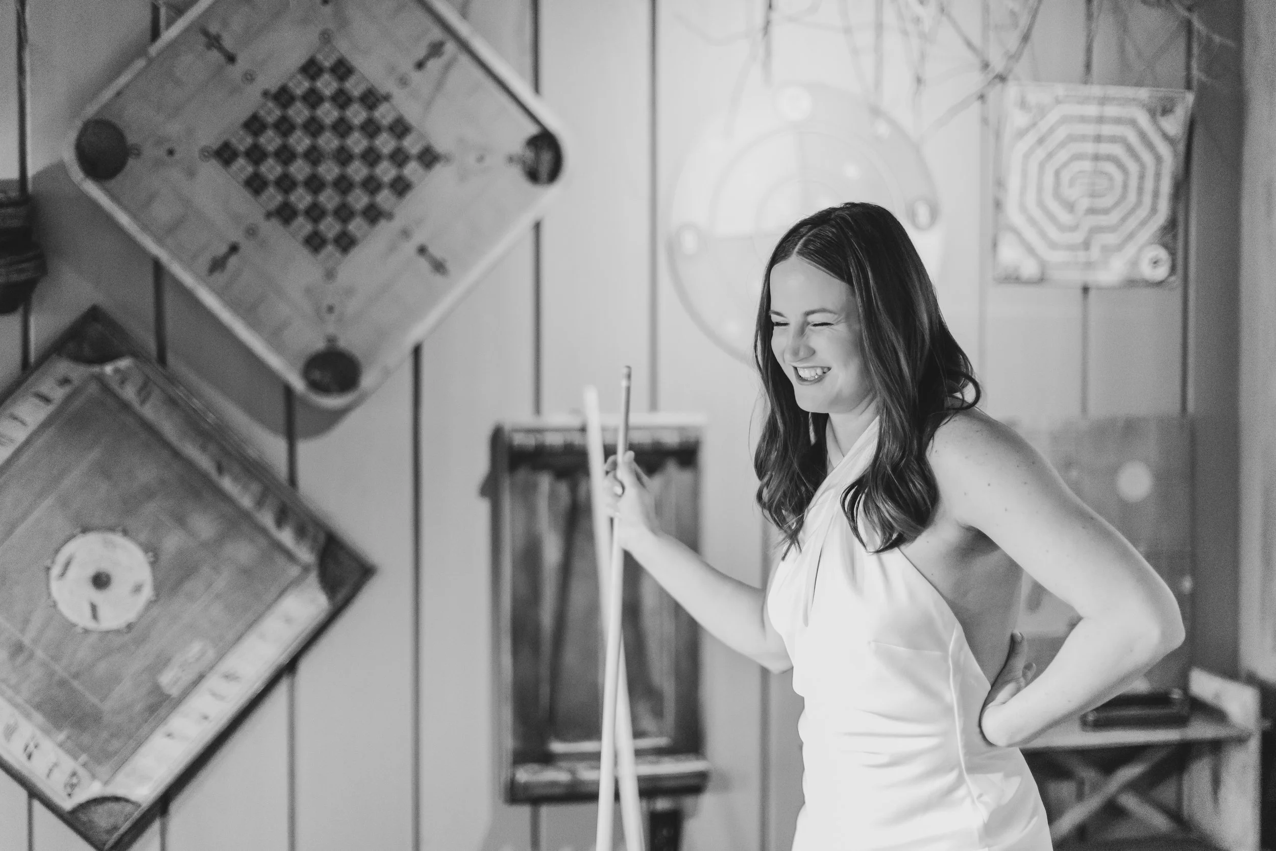 Couple playing pool during their winter elopement at Lake Placid Lodge