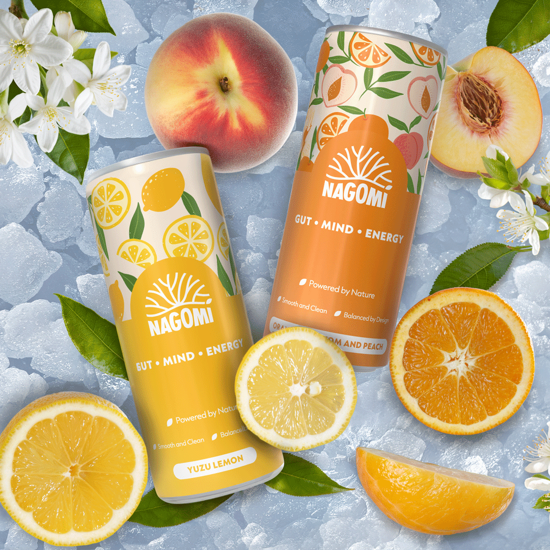 Two cans of Nagomi drinks surrounded by orange blossom, citric fruit and leaves.