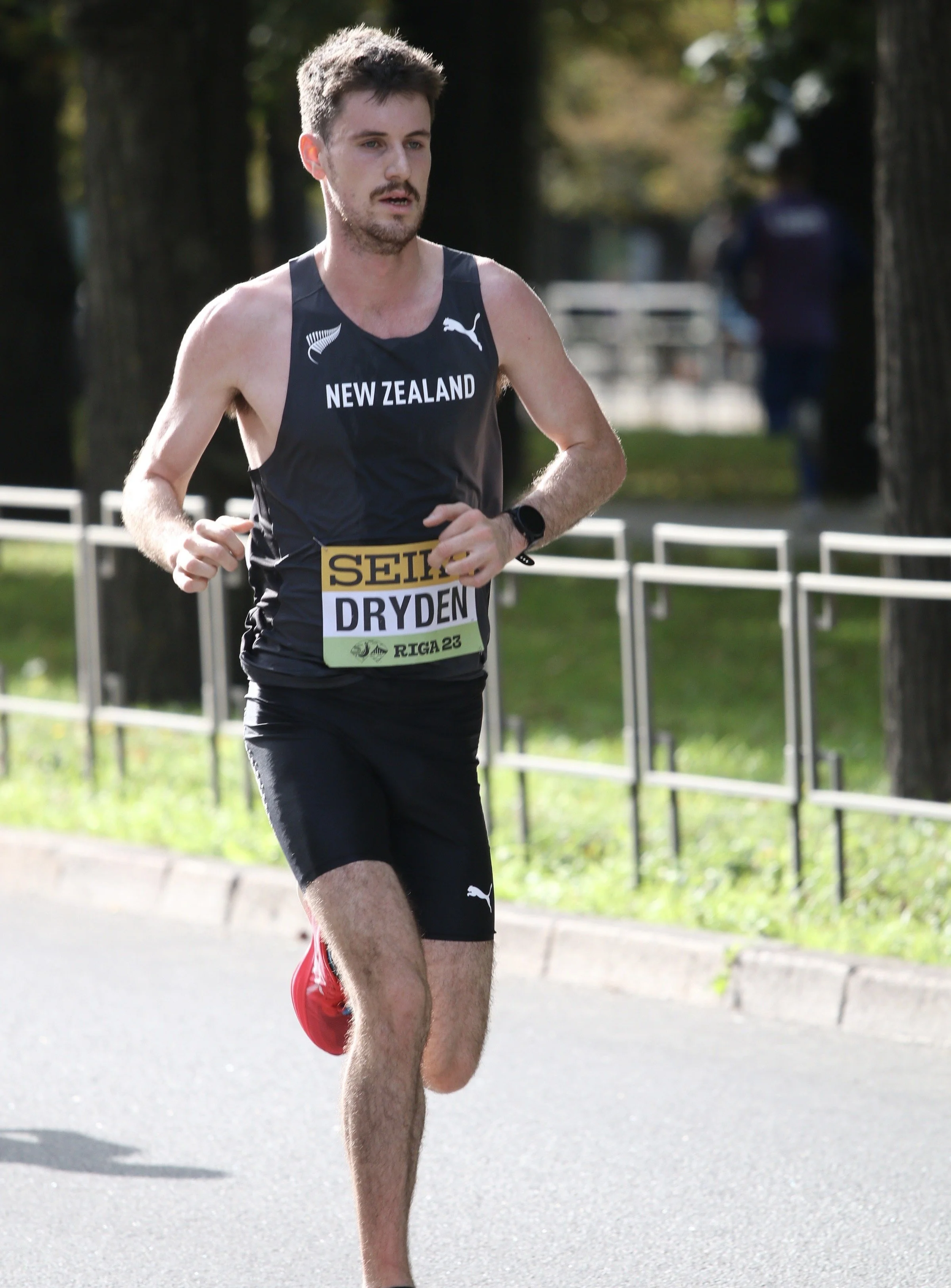 Christopher Dryden running in New Zealand representative singlet