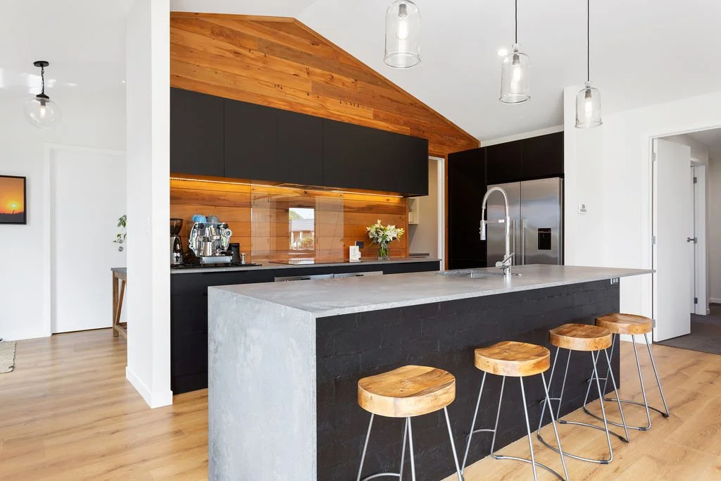 Modern kitchen renovation in Waikato with island bench and timber ceiling by MDB Homes