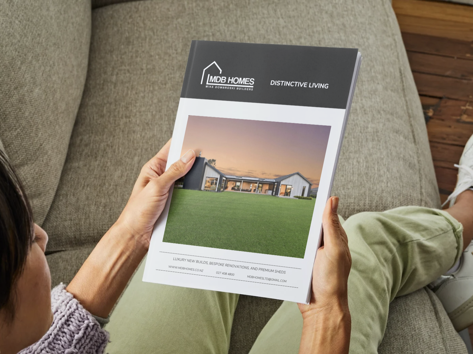 Lady looking at a brochure by MDB Homes because she wants to renovate or build a lifestyle block in Cambridge Waikato.