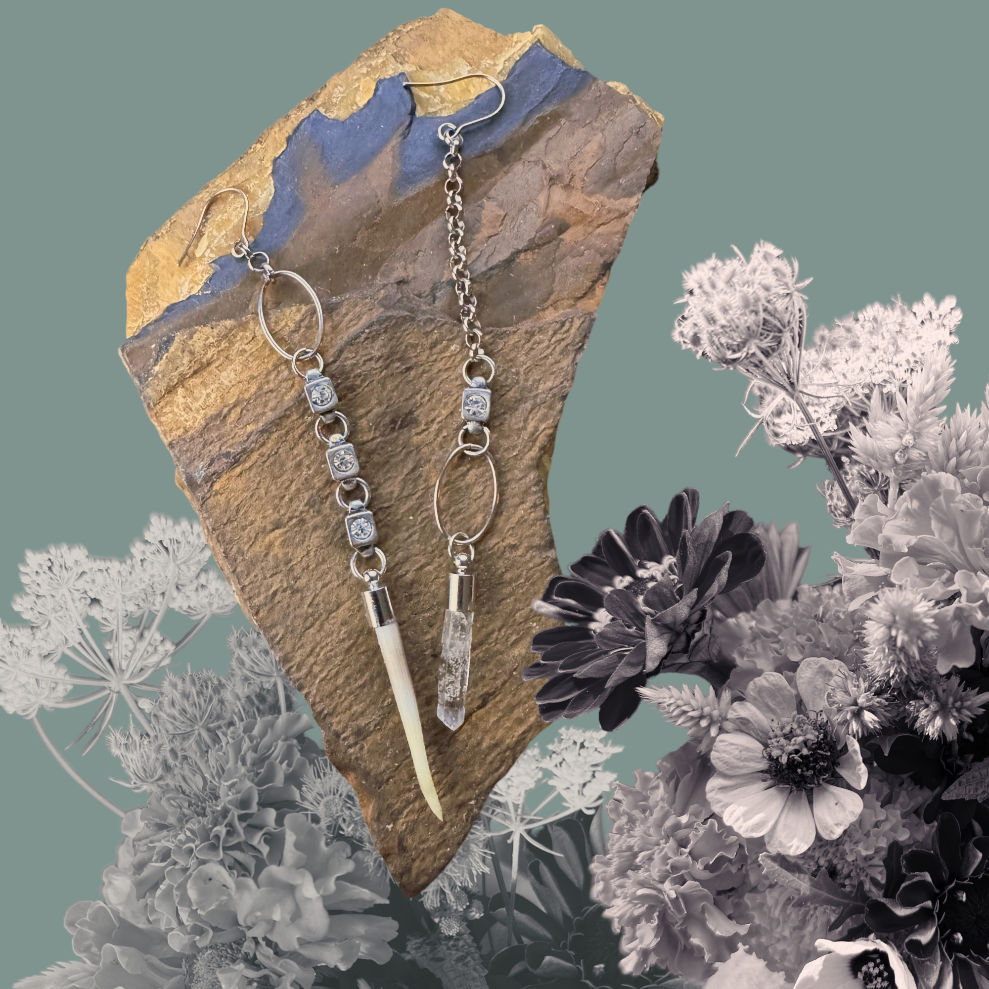 Artistic earrings on a rock background with flowers